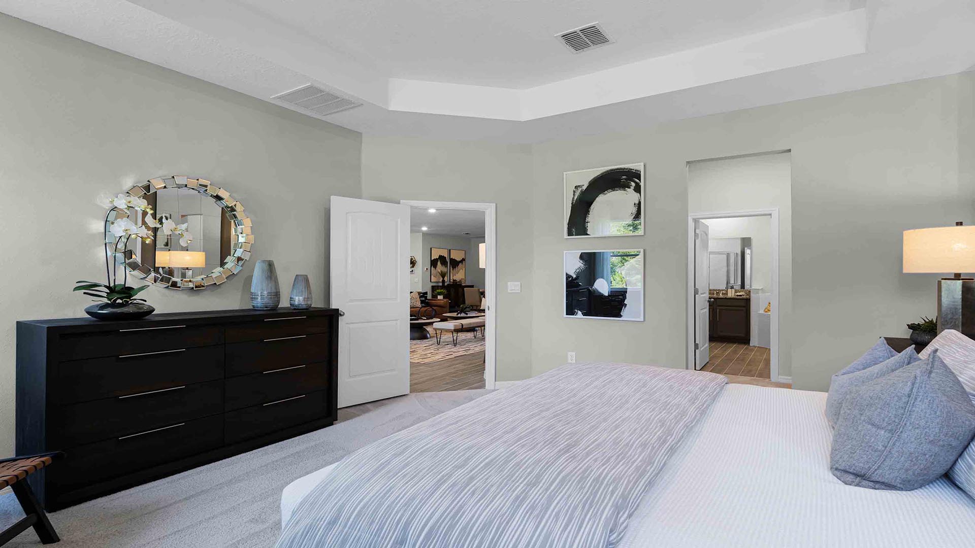 primary master bedroom with access to master bathroom and living area.