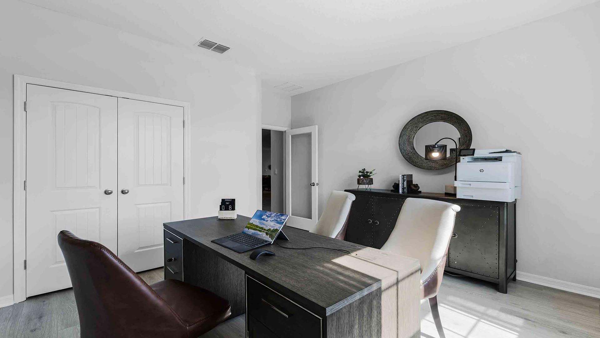 Functional home office with desk, chairs and space to work or play.