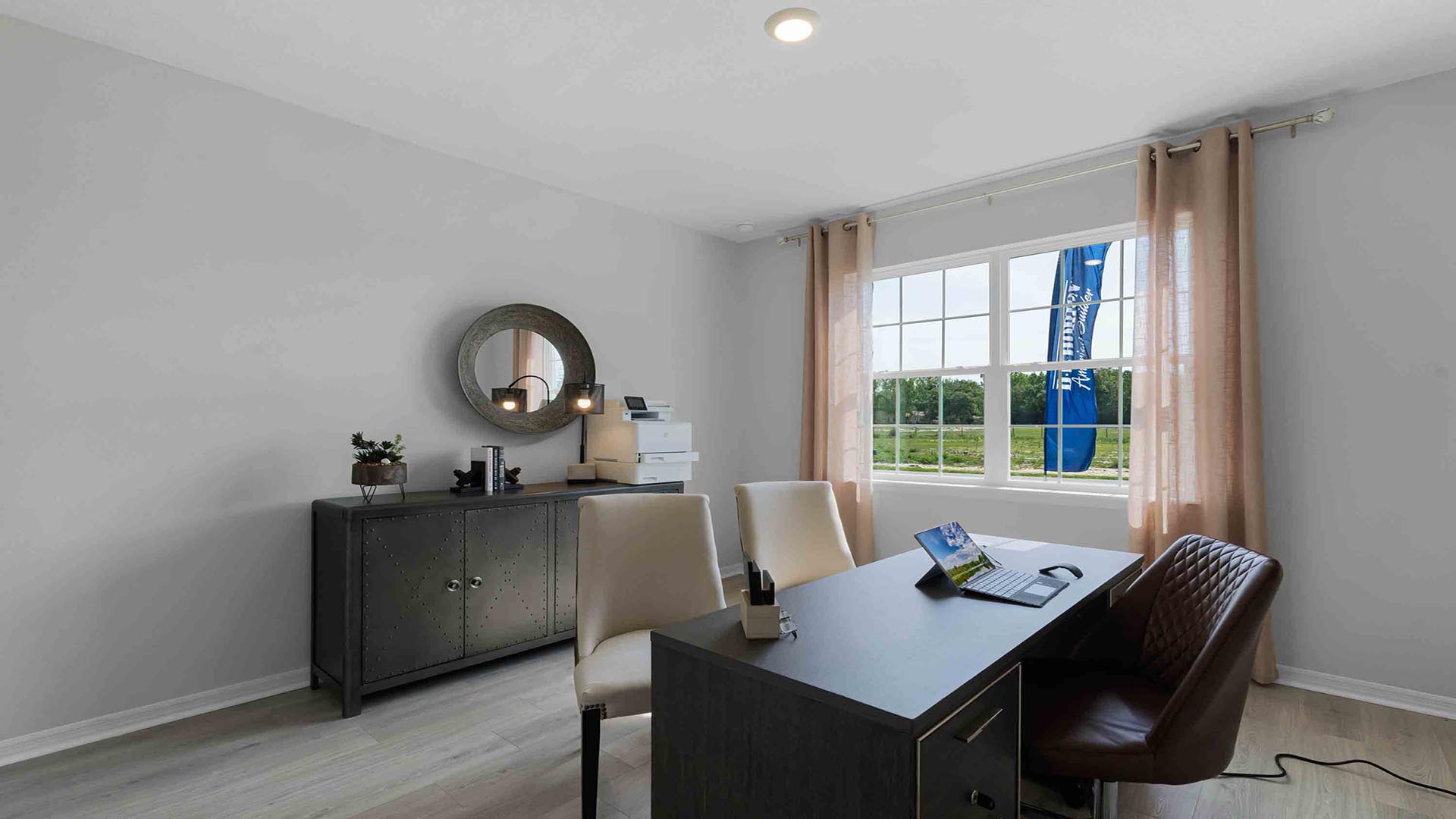 Functional home office with desk, chairs and space to work or play.