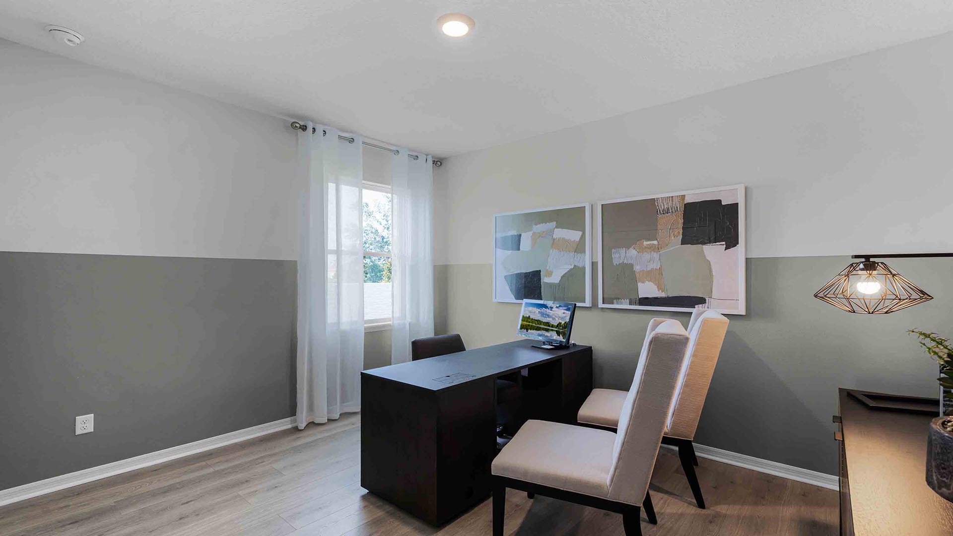 Functional home office with desk, chairs and space to work or play.