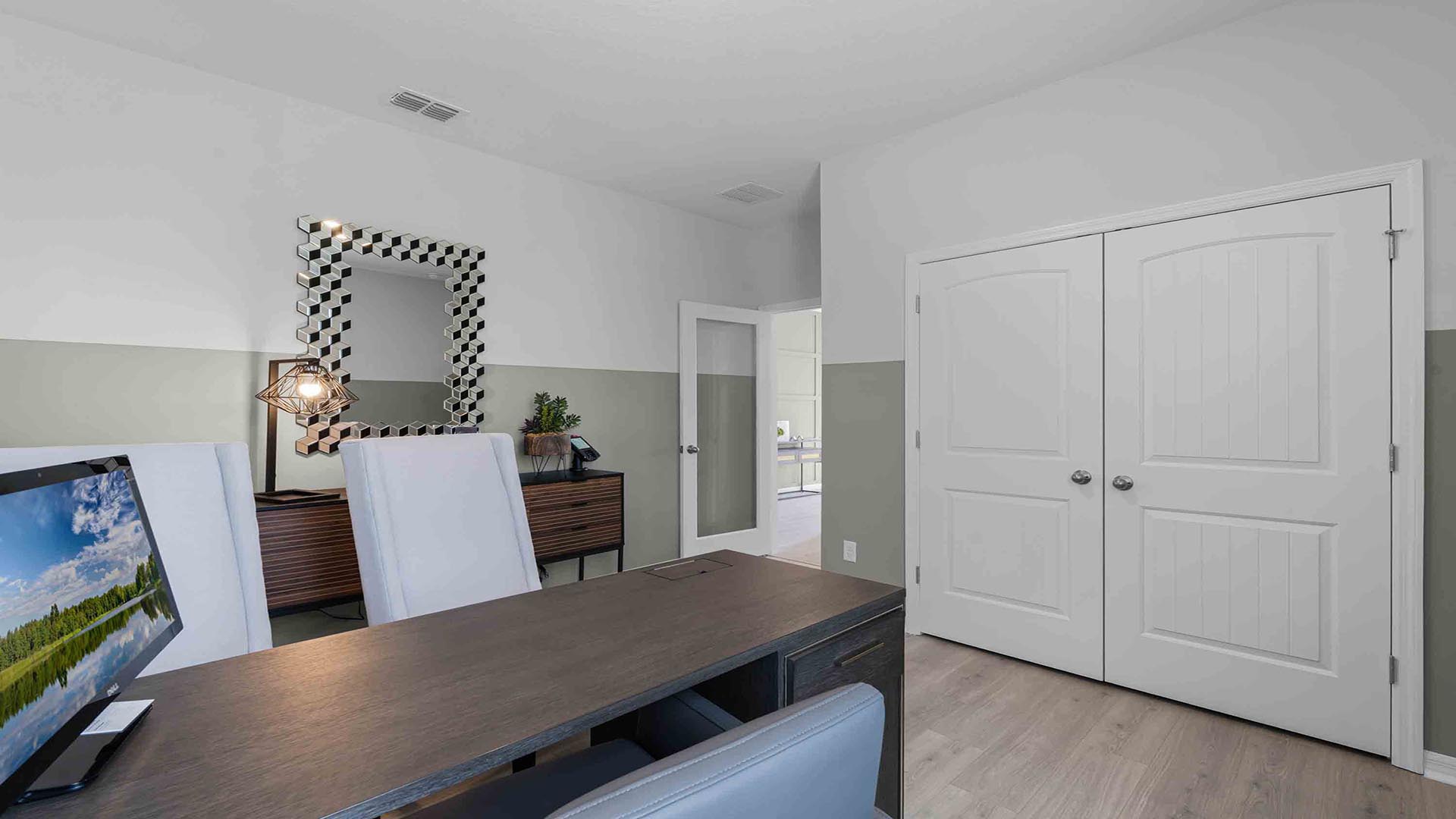 Functional home office with desk, chairs and space to work or play.