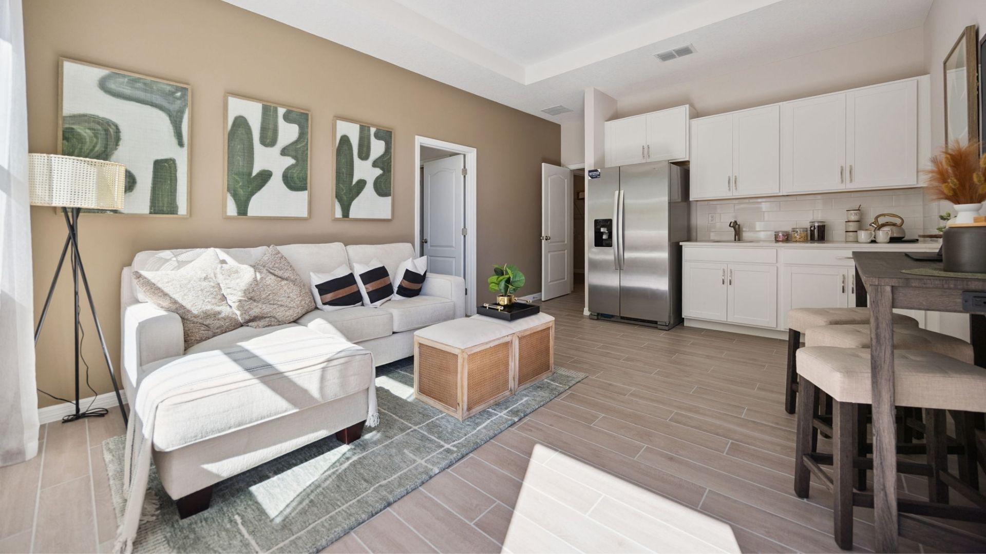Guest bedroom with bed, nighstand, desk, and natural lighting.