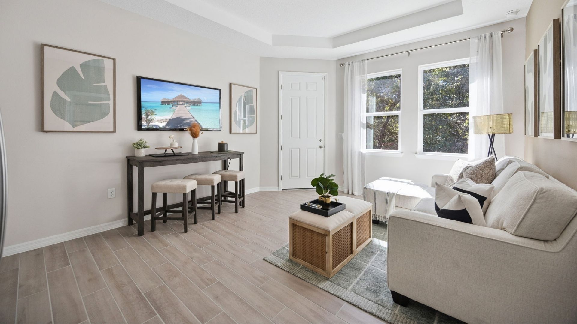 Guest bedroom with bed, nighstand, desk, and natural lighting.