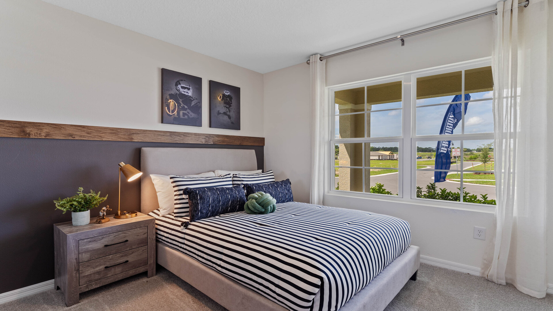Guest bedroom with bed, nighstands and natural lighting.