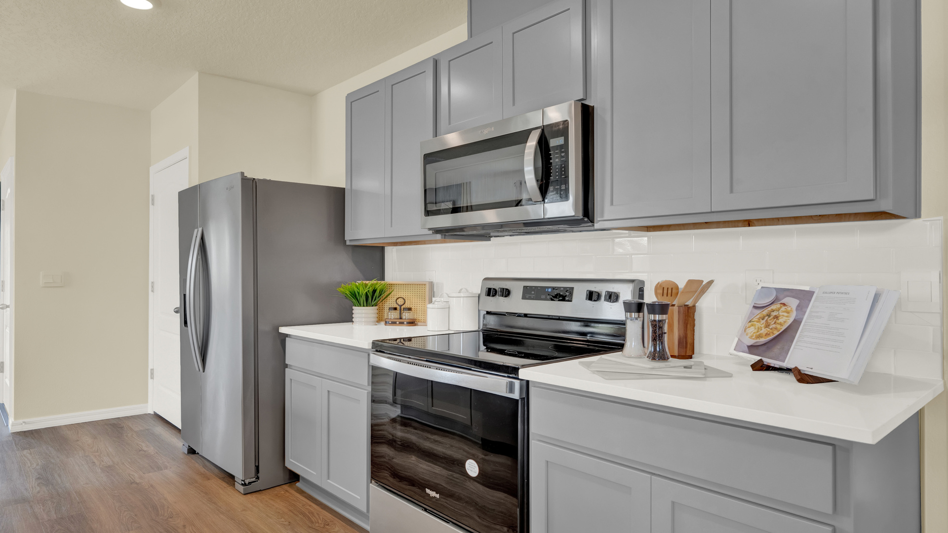 Kitchen with tall cabinetry, appliances, walk in pantry