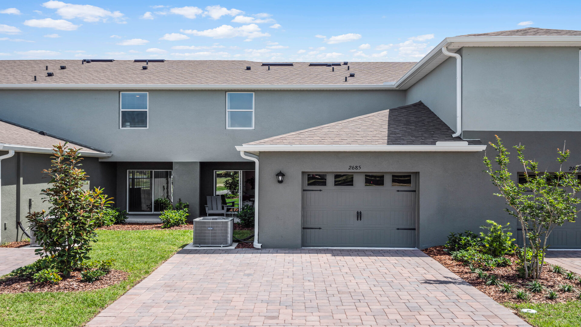 Attached townhome with concrete block construction and a one-car garage.