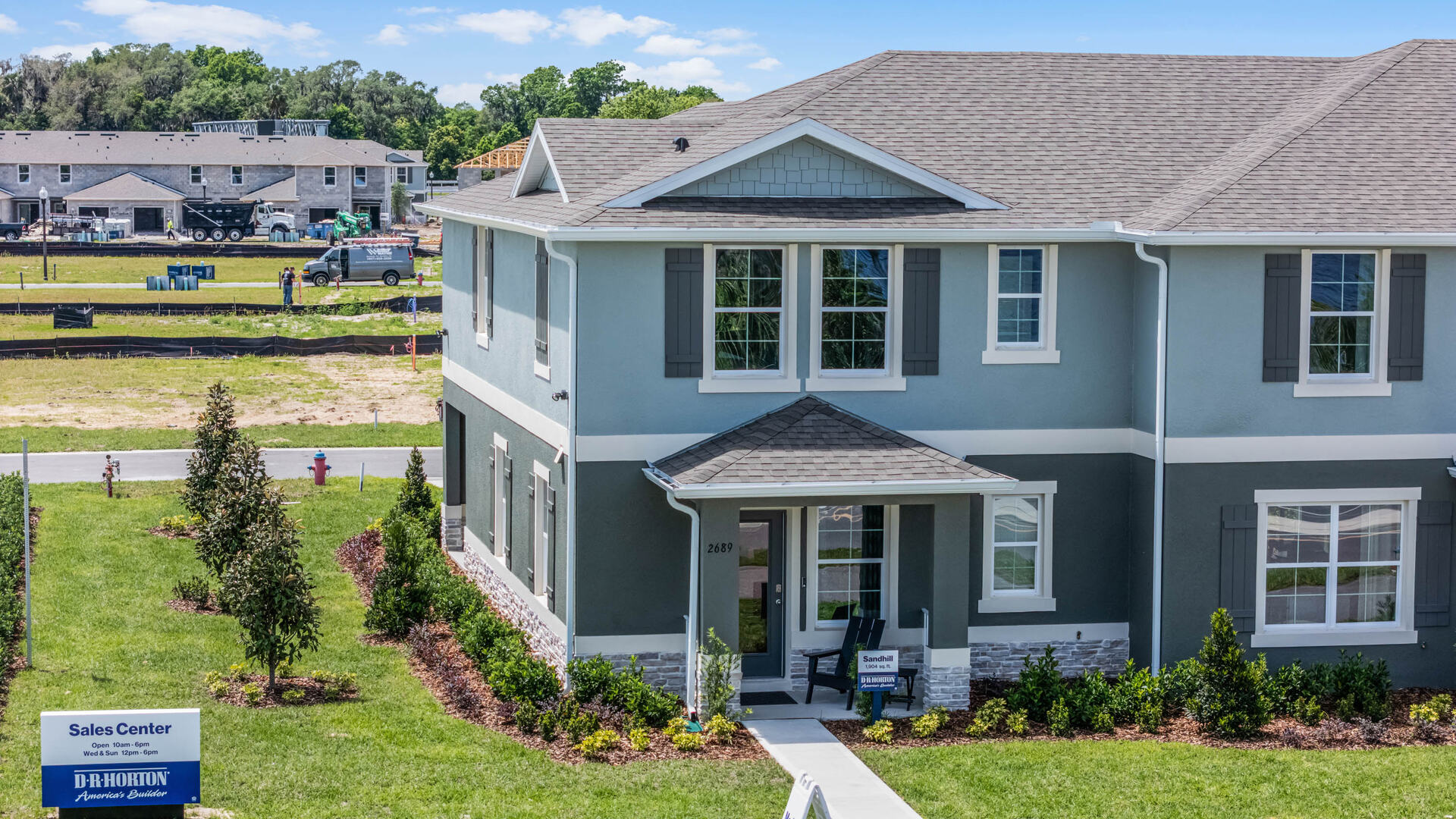 Two story Attached townhome with concrete block construction and a one-car garage.