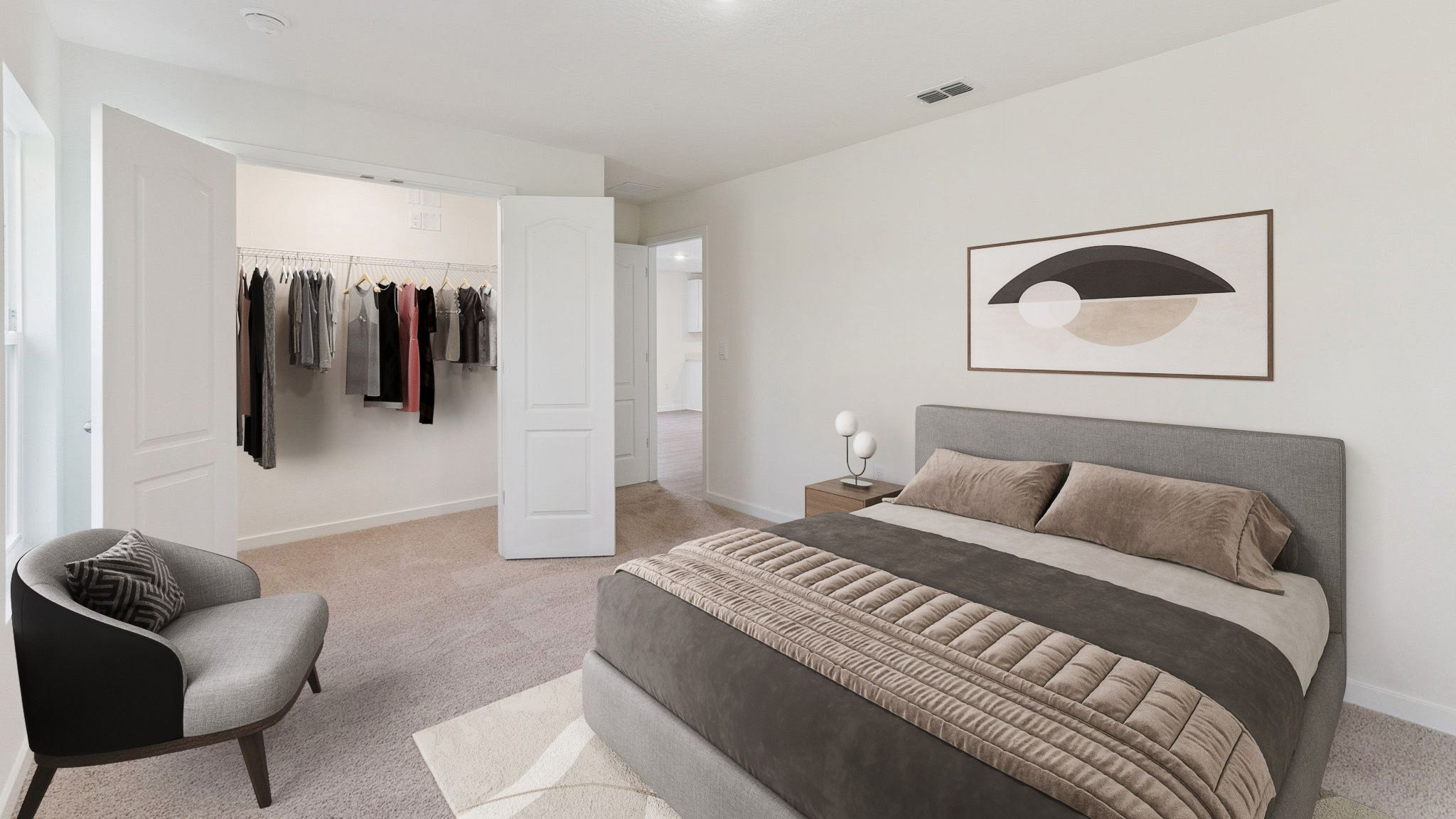 Spacious primary bedroom with king size bed, carpet flooring, natural lighting showing access to primary bathroom.