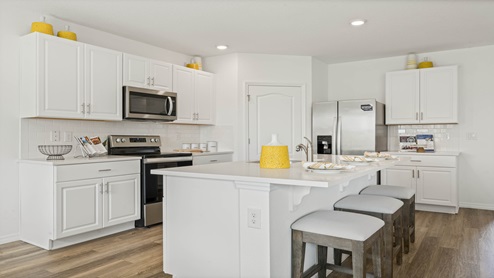 Kitchen with quartz counters and laminate flooring
