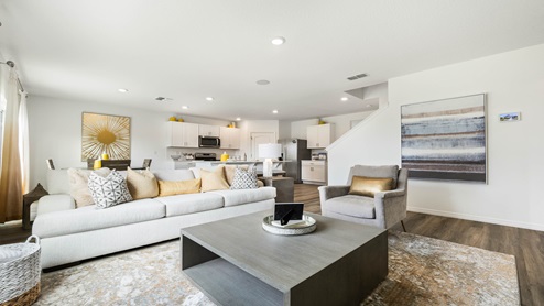 Living area with laminate flooring overseeing kitchen