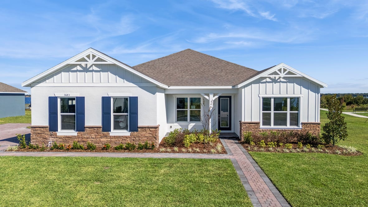 Single story new home with large windows and 3 car side garage.