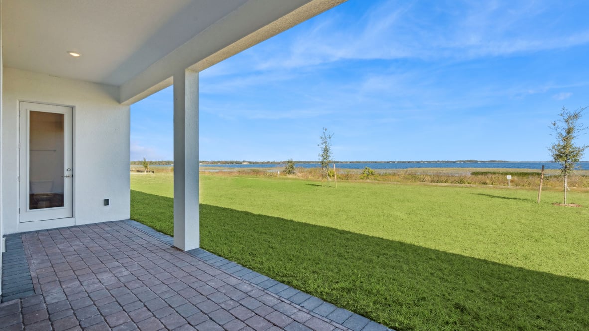 rear of home with lake view