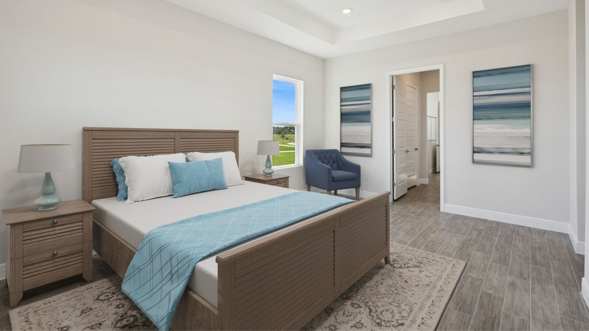 Spacious primary bedroom with king size bed, carpet flooring, natural lighting.