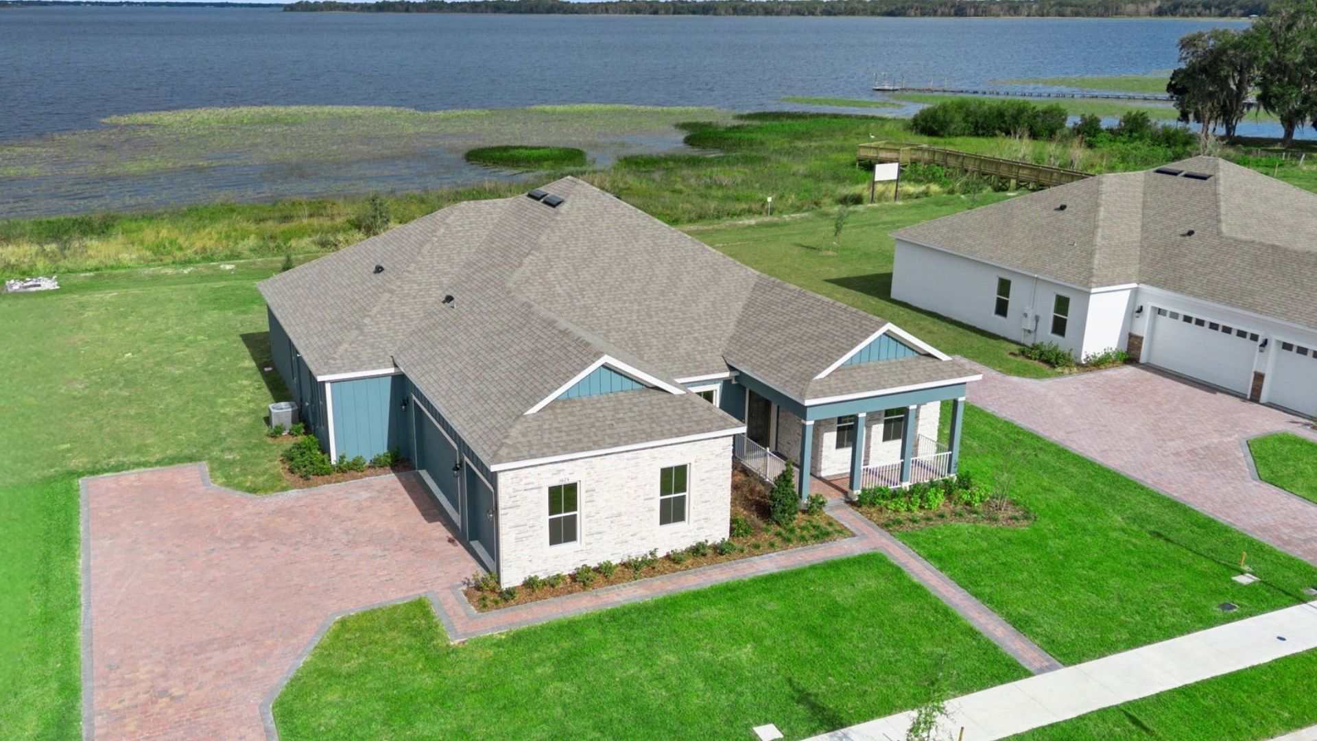Single story new home with large windows and 2 car garage.