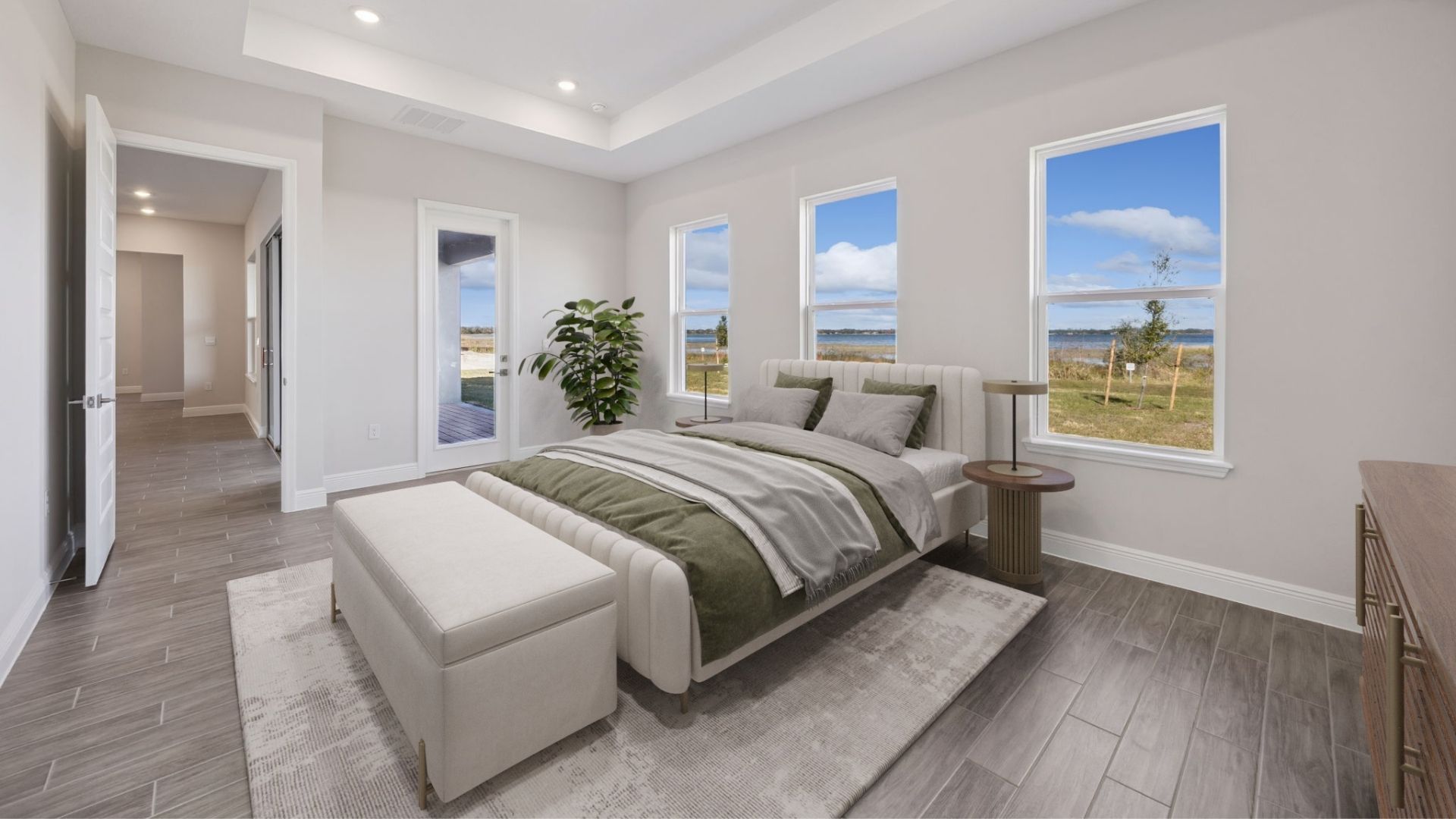 primary bedroom with lake view and king sized bed