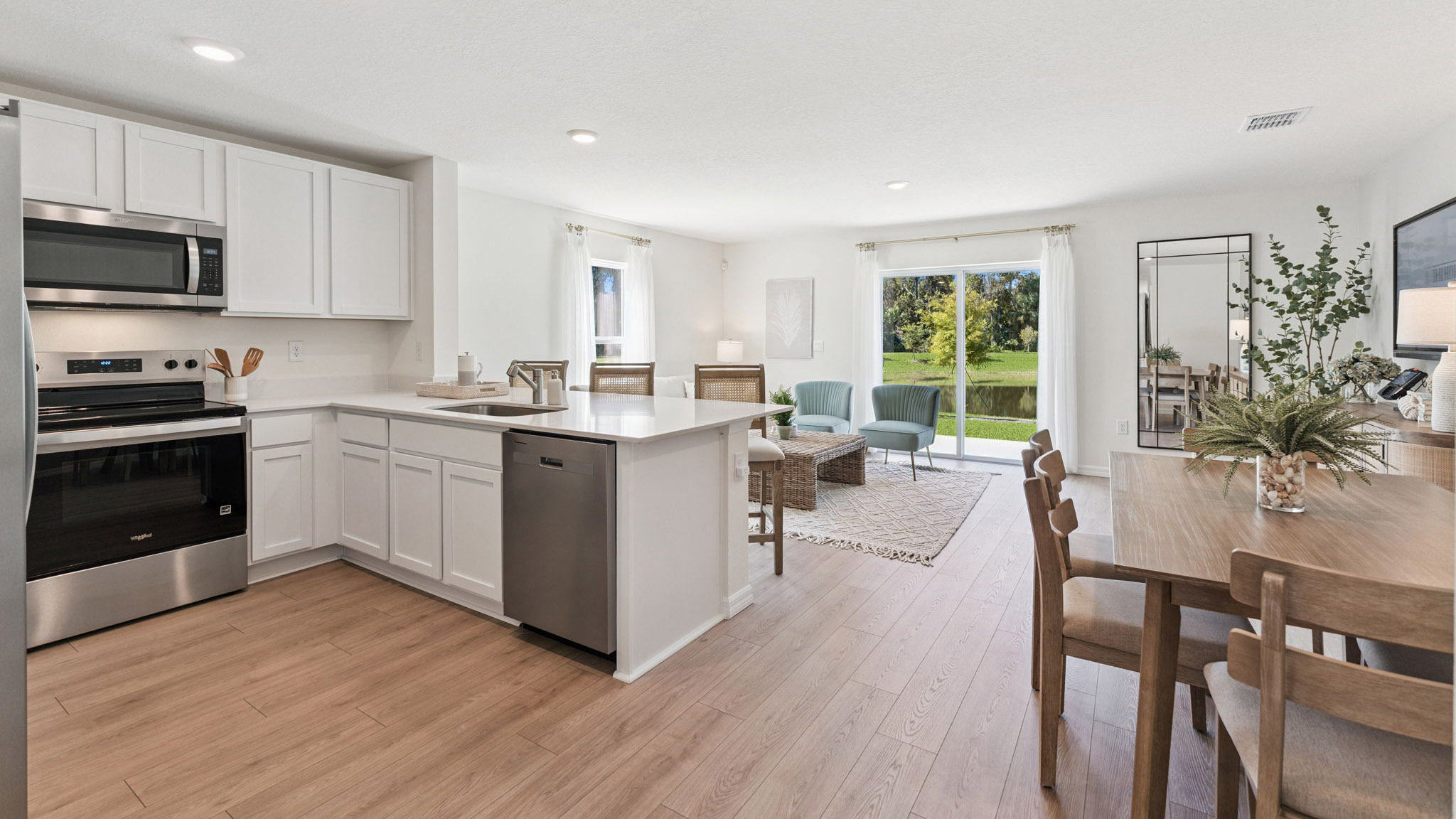 kitchen with quartz countertops overseeing living area and dining room table