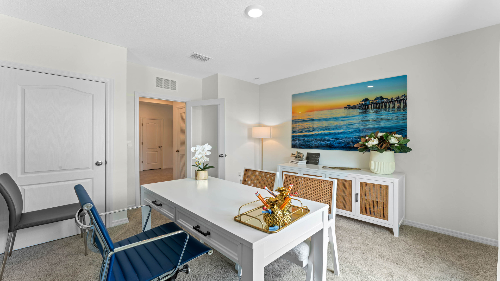 Functional home office with desk, chairs and space to work or play.