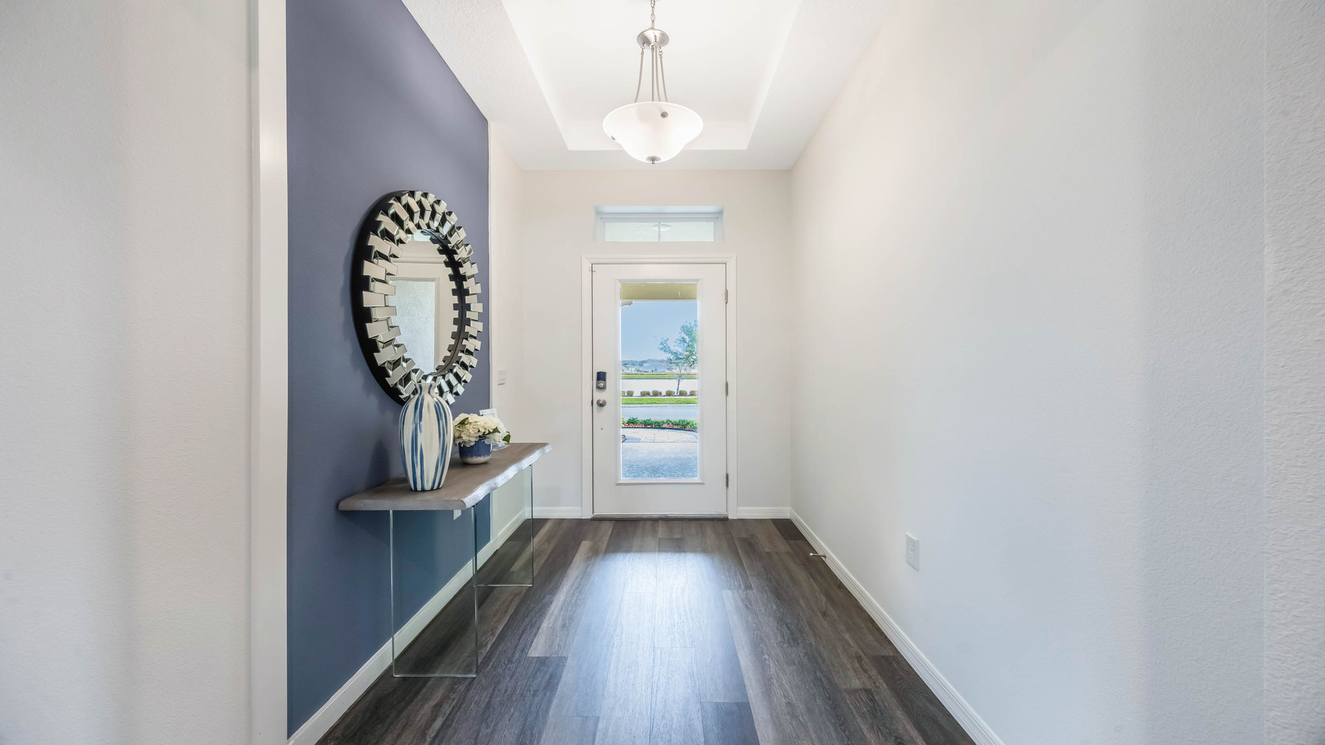 Entry way with laminate flooring showing front door.