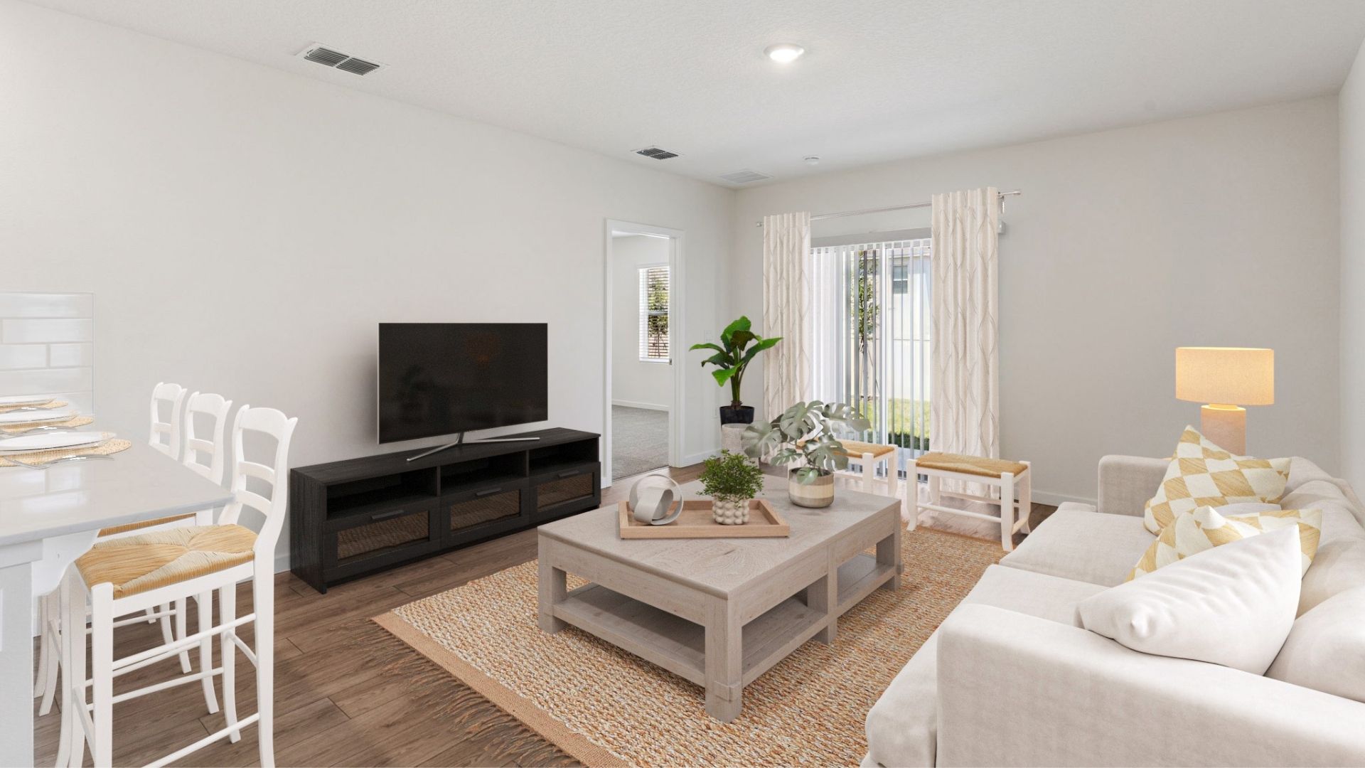 Open concept living area with couch seating and backyard access.