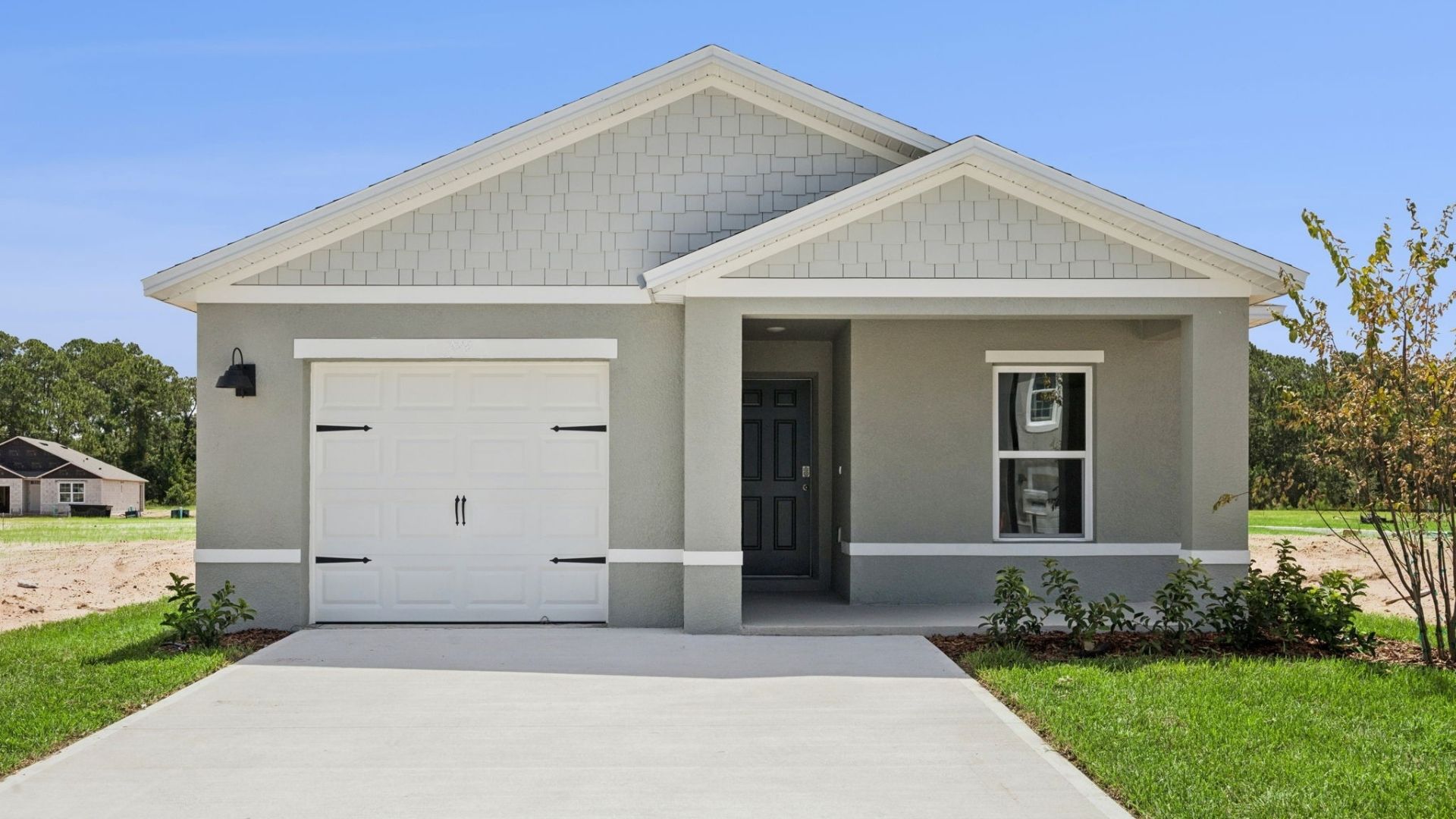 Single story new home with large windows and 2 car garage.