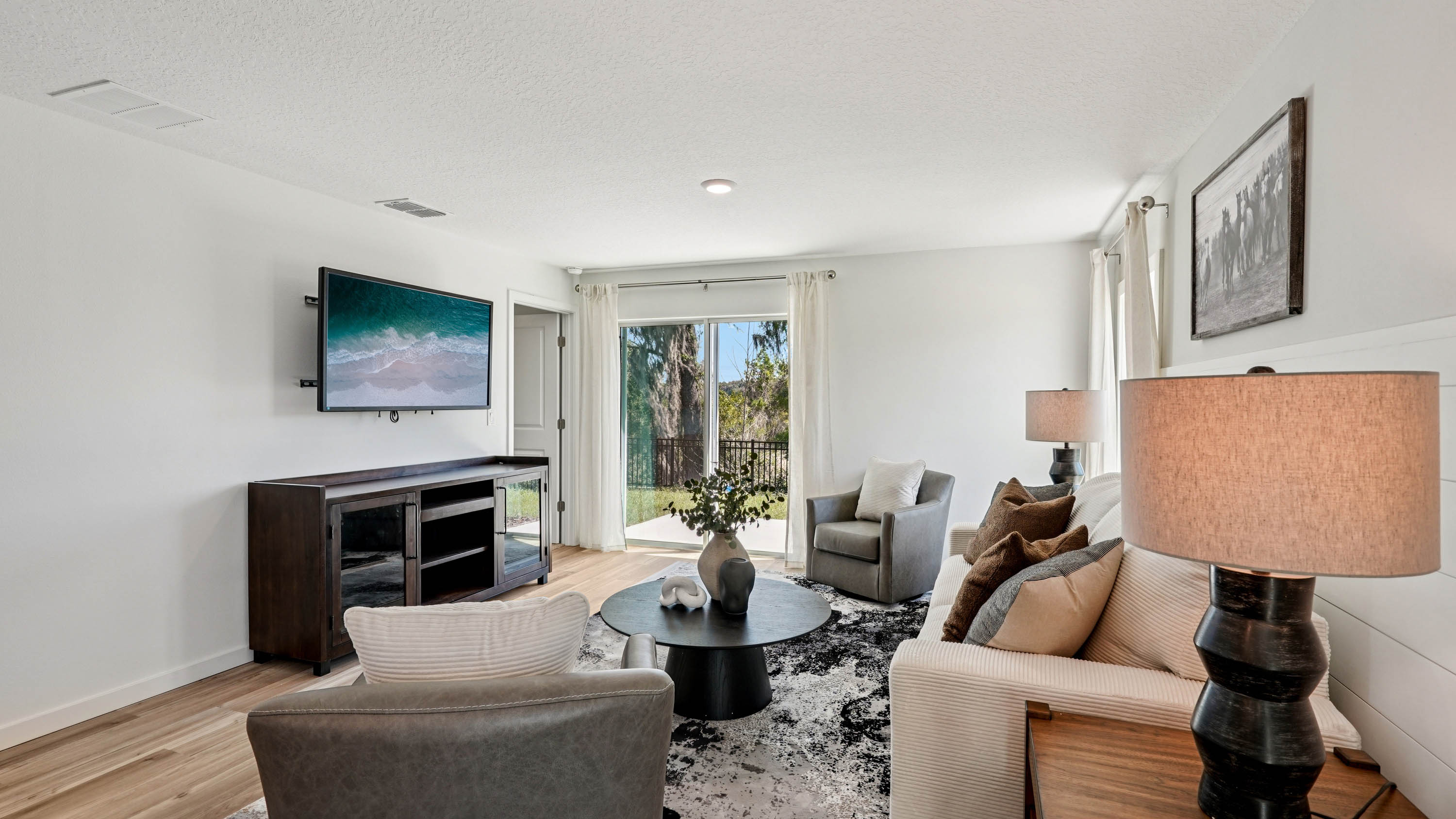 Living area with seating, entertainment system and natural lighting