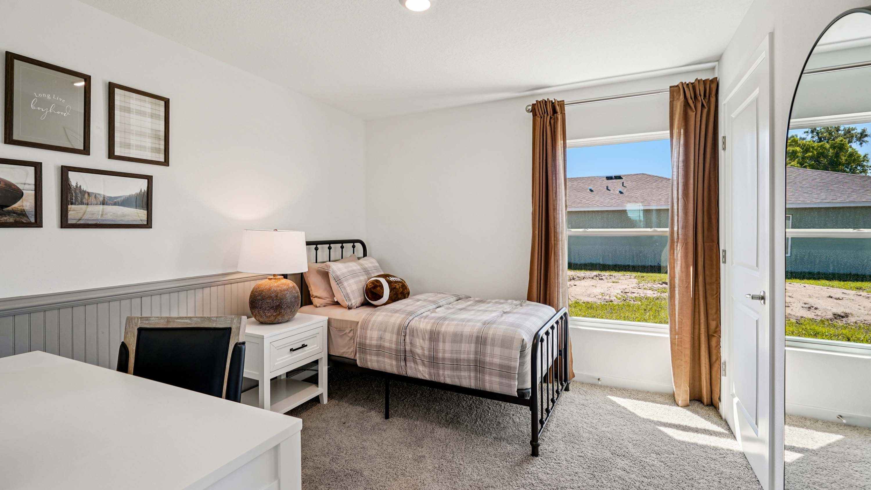 Guest bedroom with bed, nighstands and natural lighting.