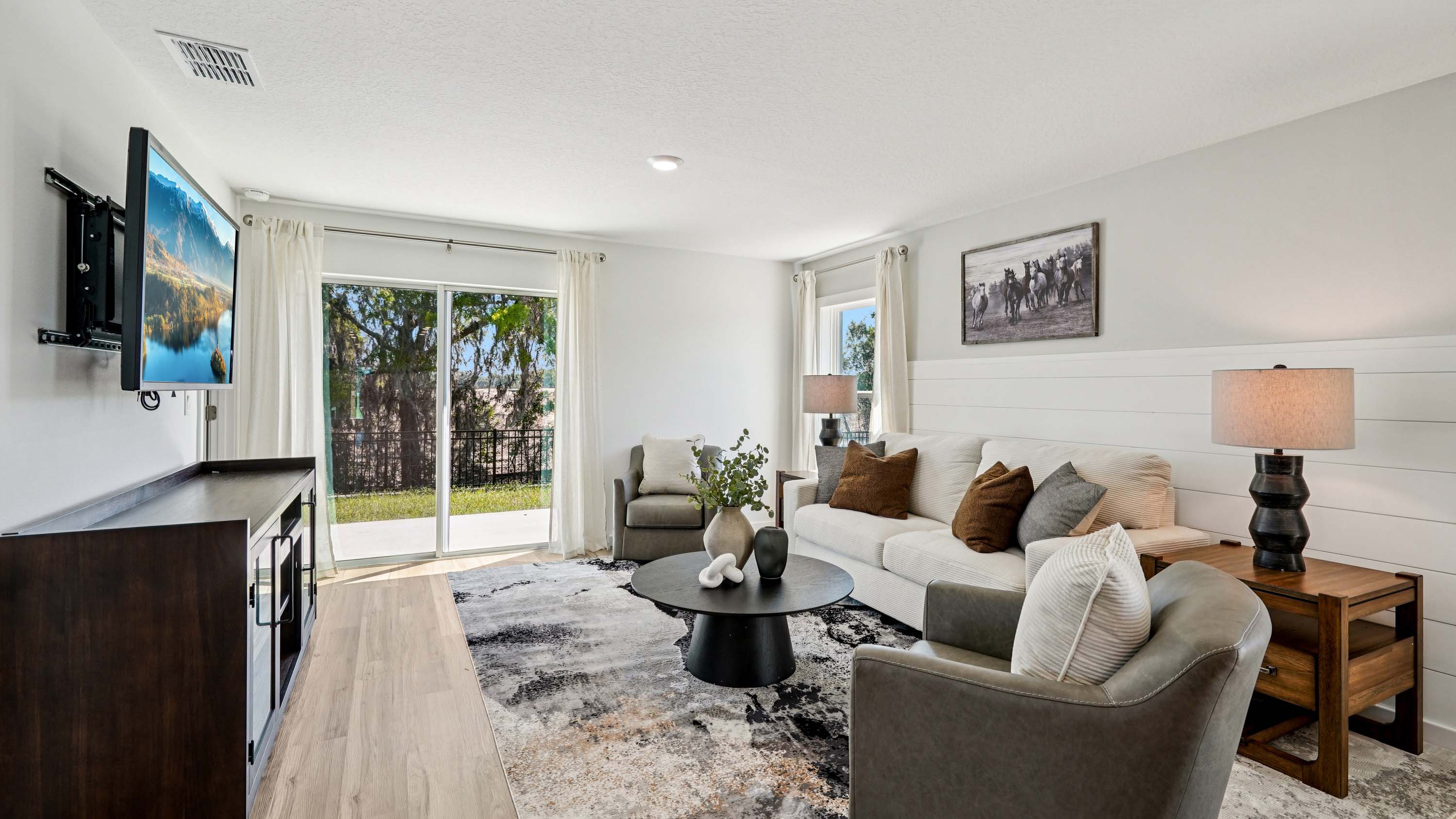 Living area with seating, entertainment system and natural lighting