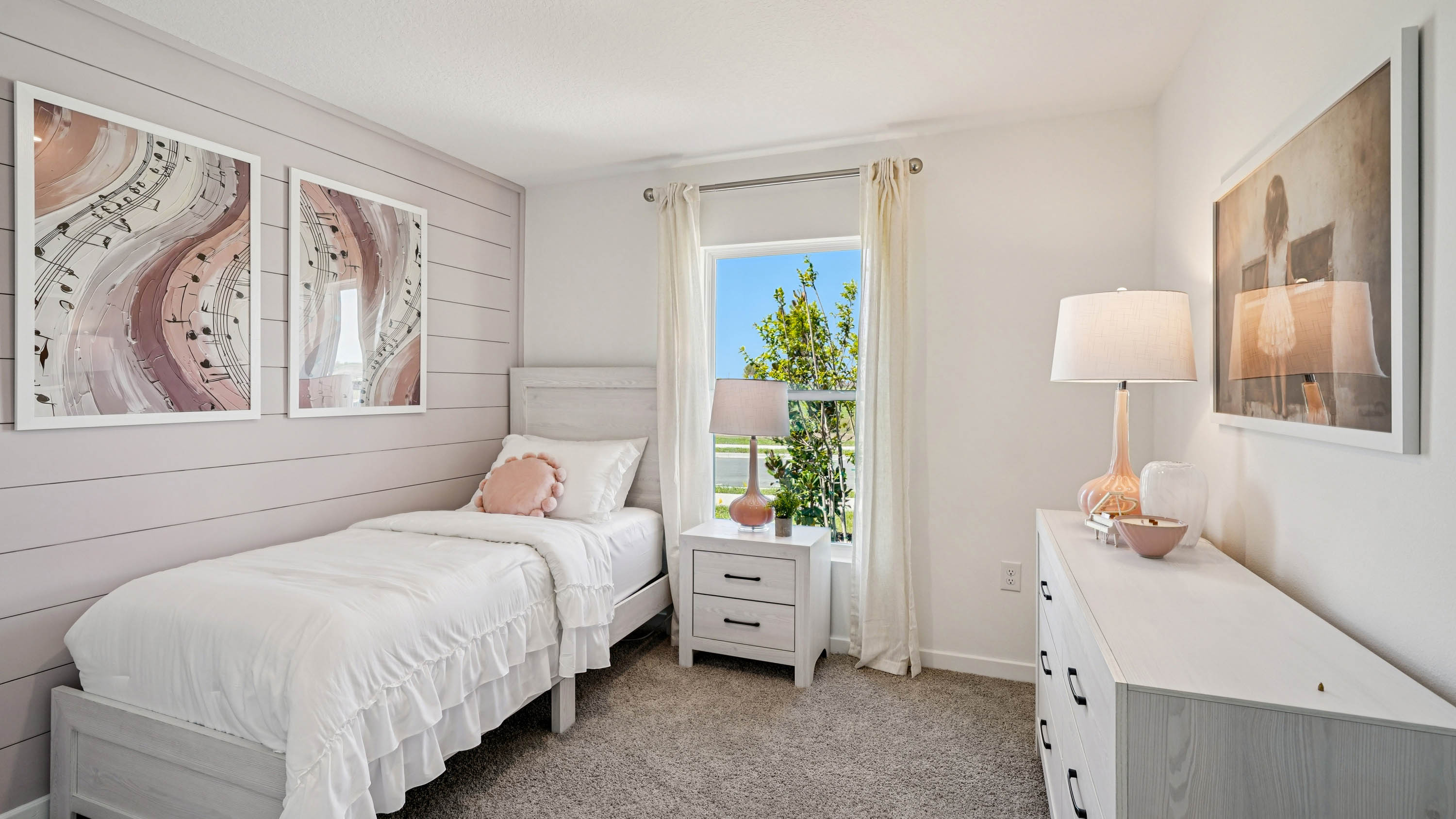 Guest bedroom with bed, nighstands and natural lighting.