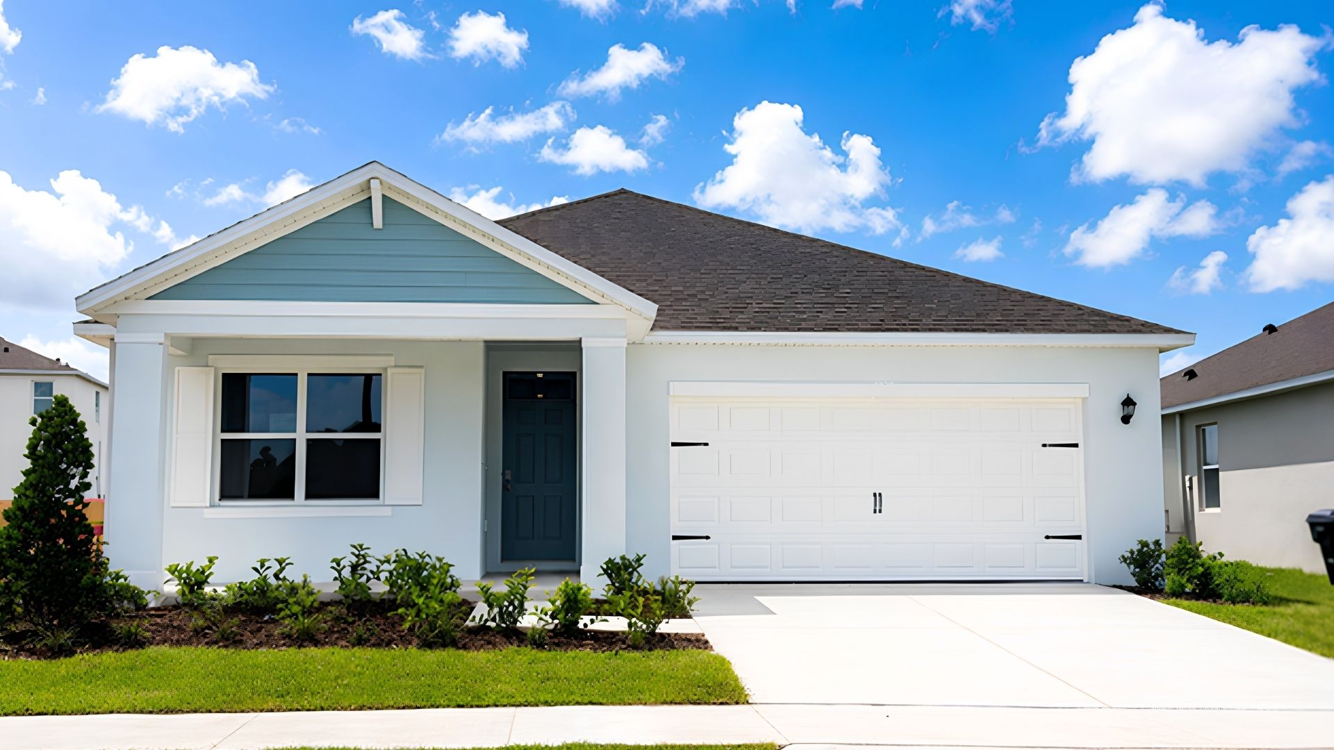 Single story new home with large windows and 2 car garage.