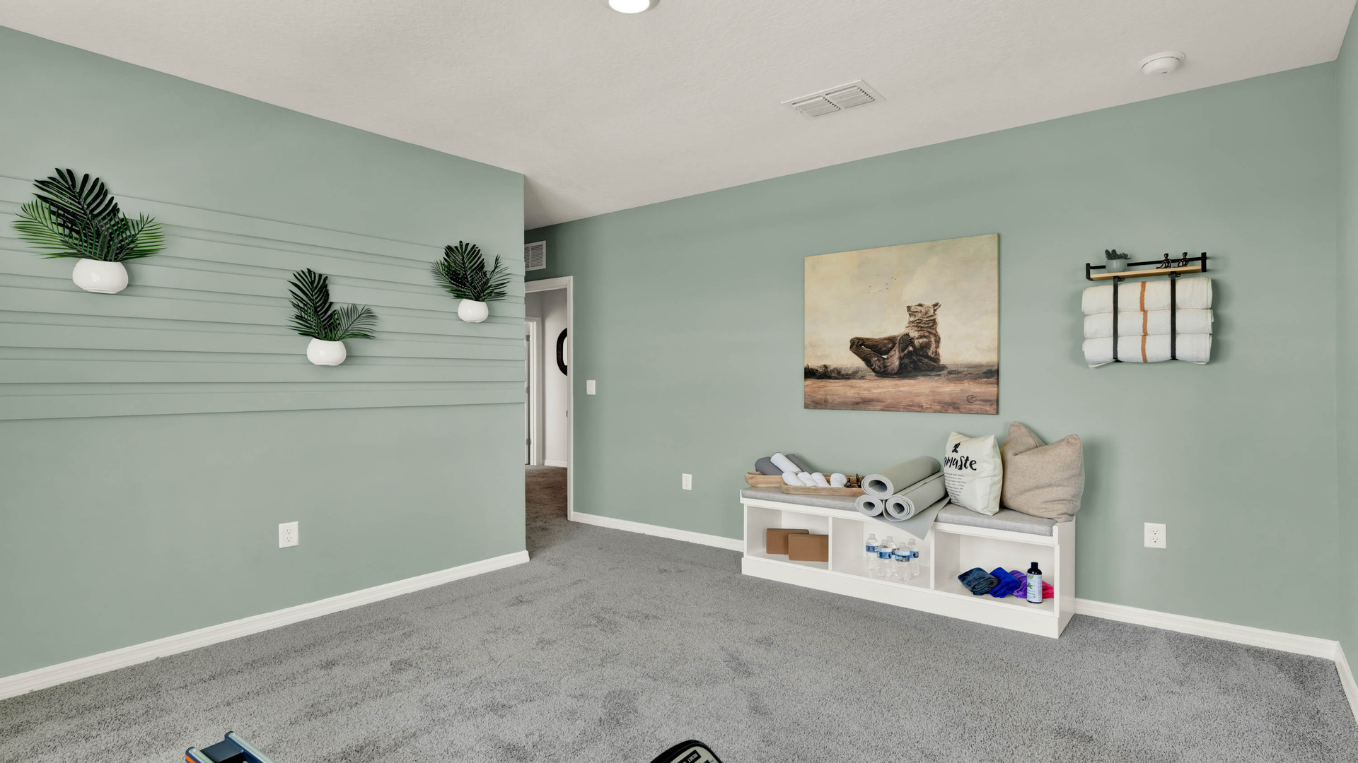 Fitness room with carpeted flooring.