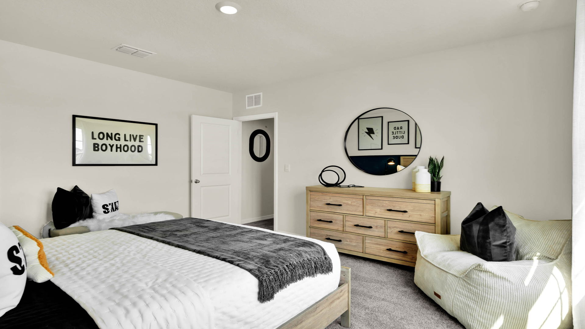 Guest bedroom with bed, nighstands and natural lighting.