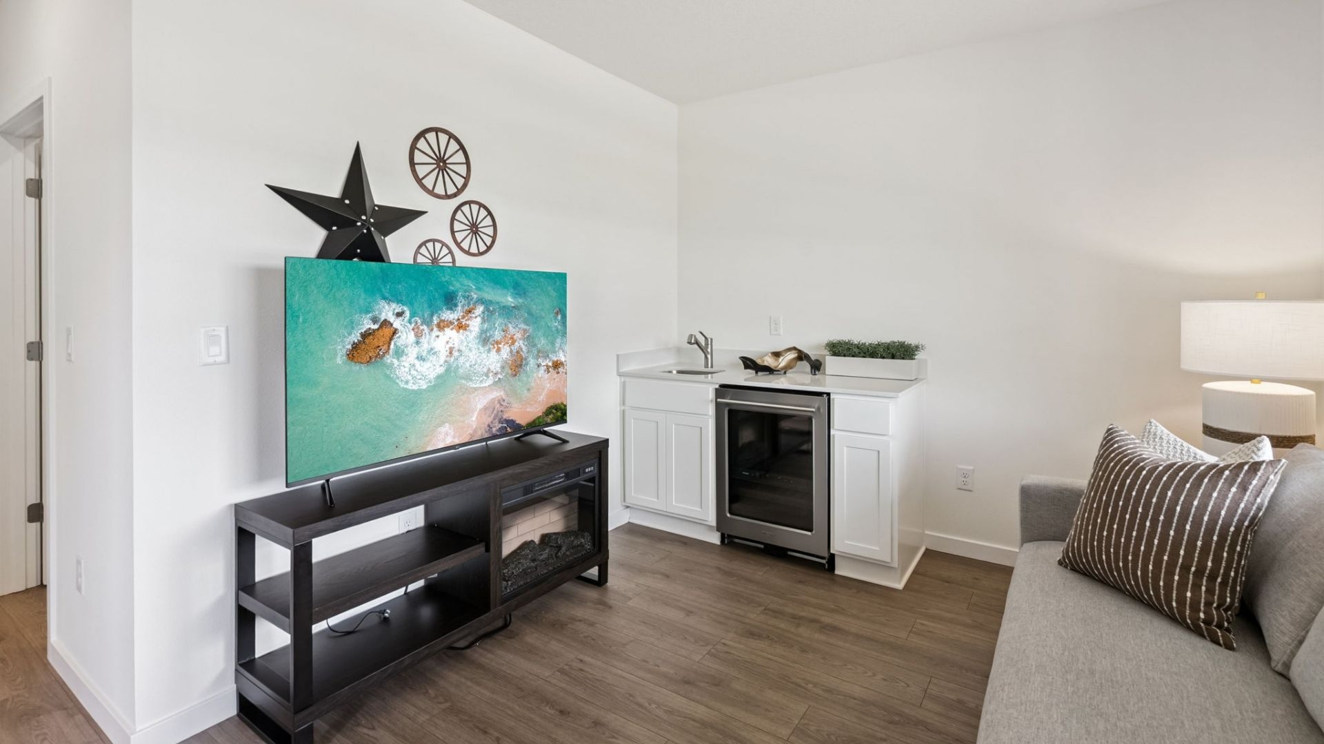 multi-gen room with couch, entertainment and small kitchen