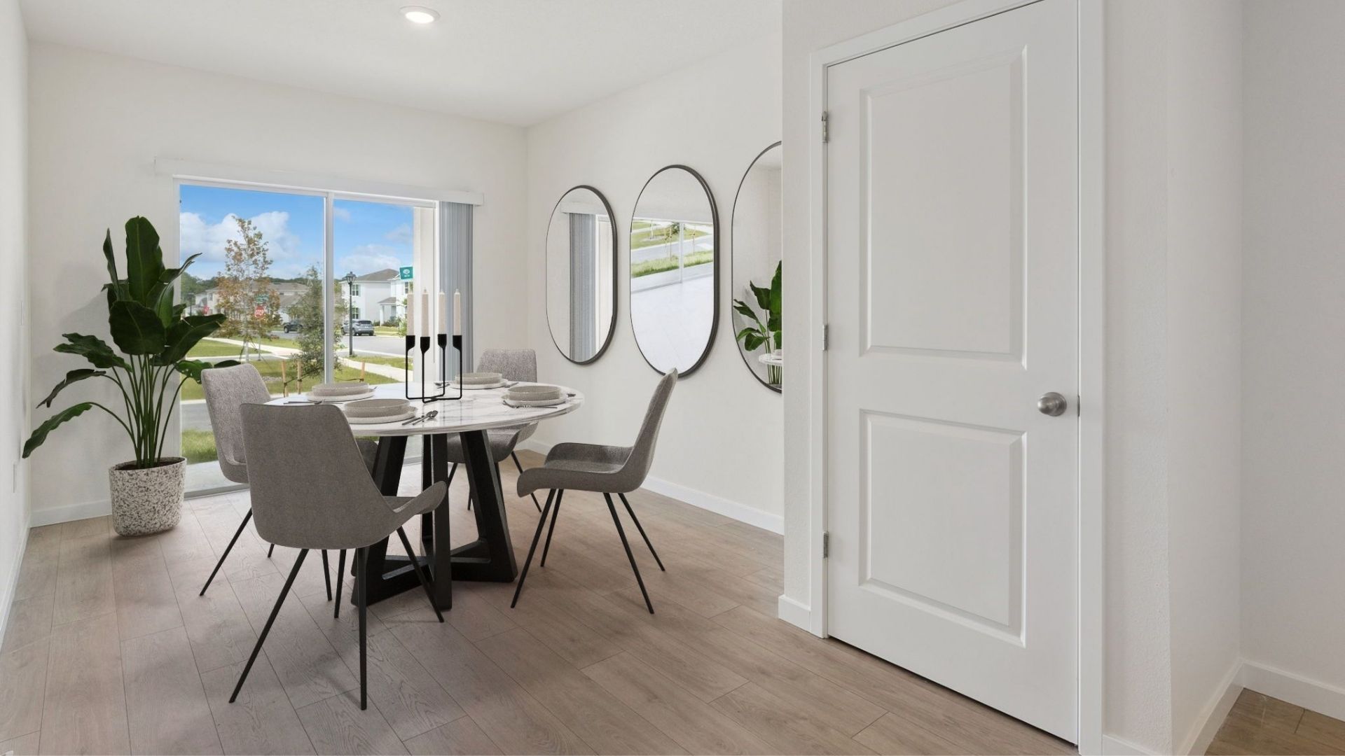 Dining room table with seating, laminate flooring, and access to backyard thru sliding doors.