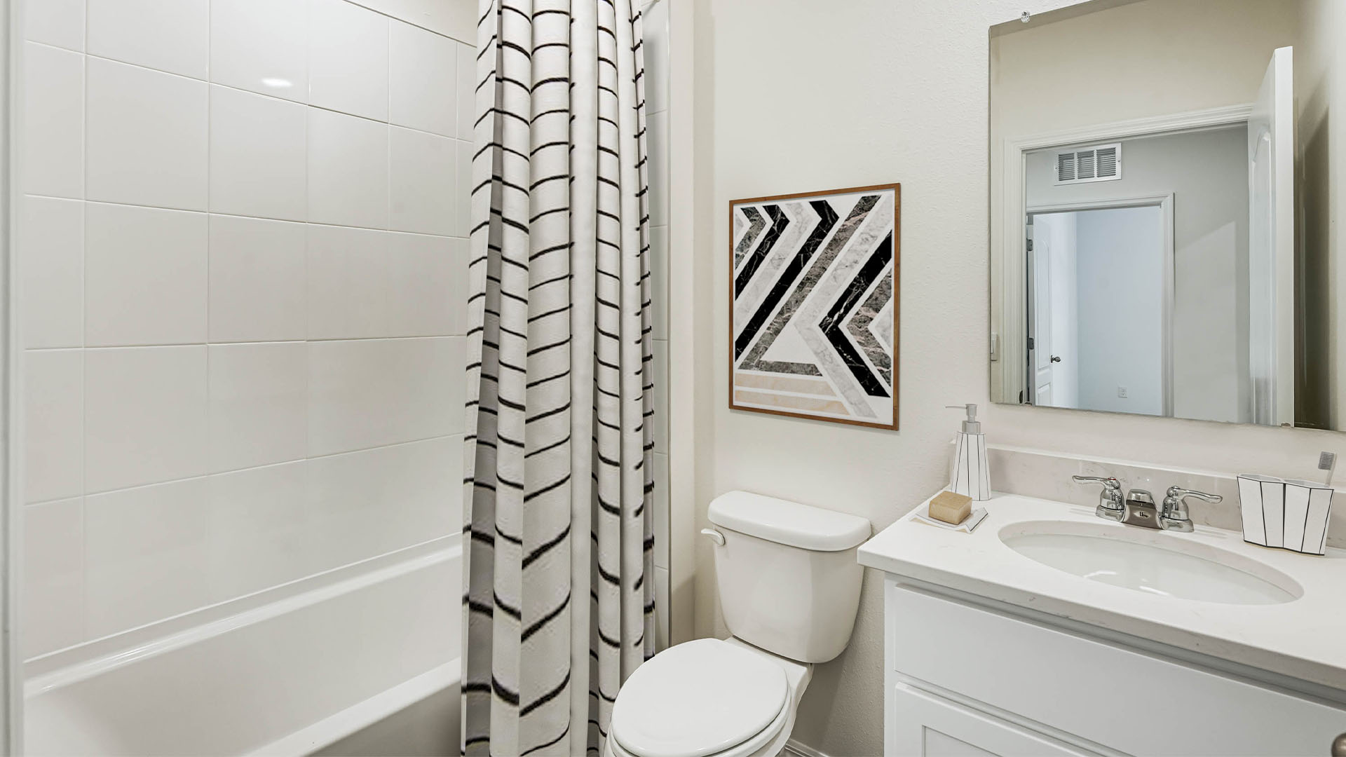 Guest bathroom with single vanity quartz countertops, toilet and shower.