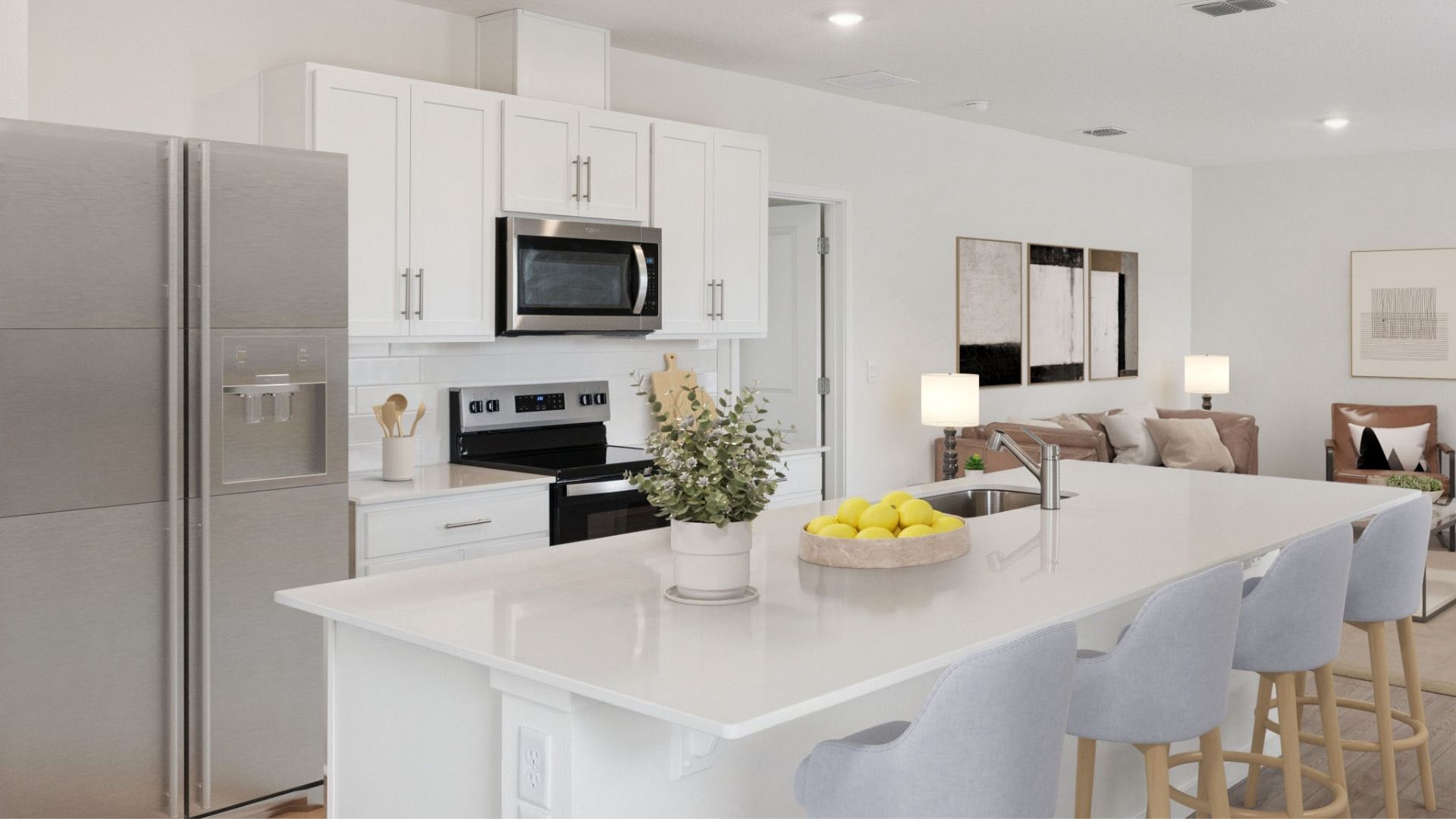 Kitchen with island seating, quartz counters, spacous pantry and stainless steel appliances.