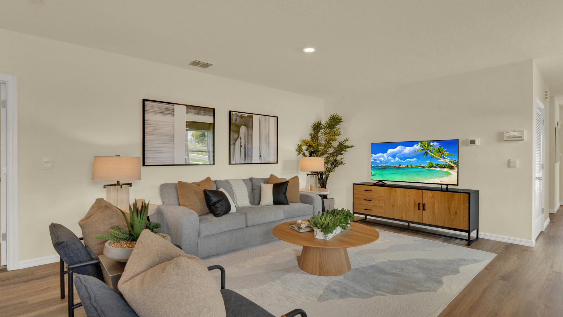 Living area with couch seating, entertainment system and natural lighting..