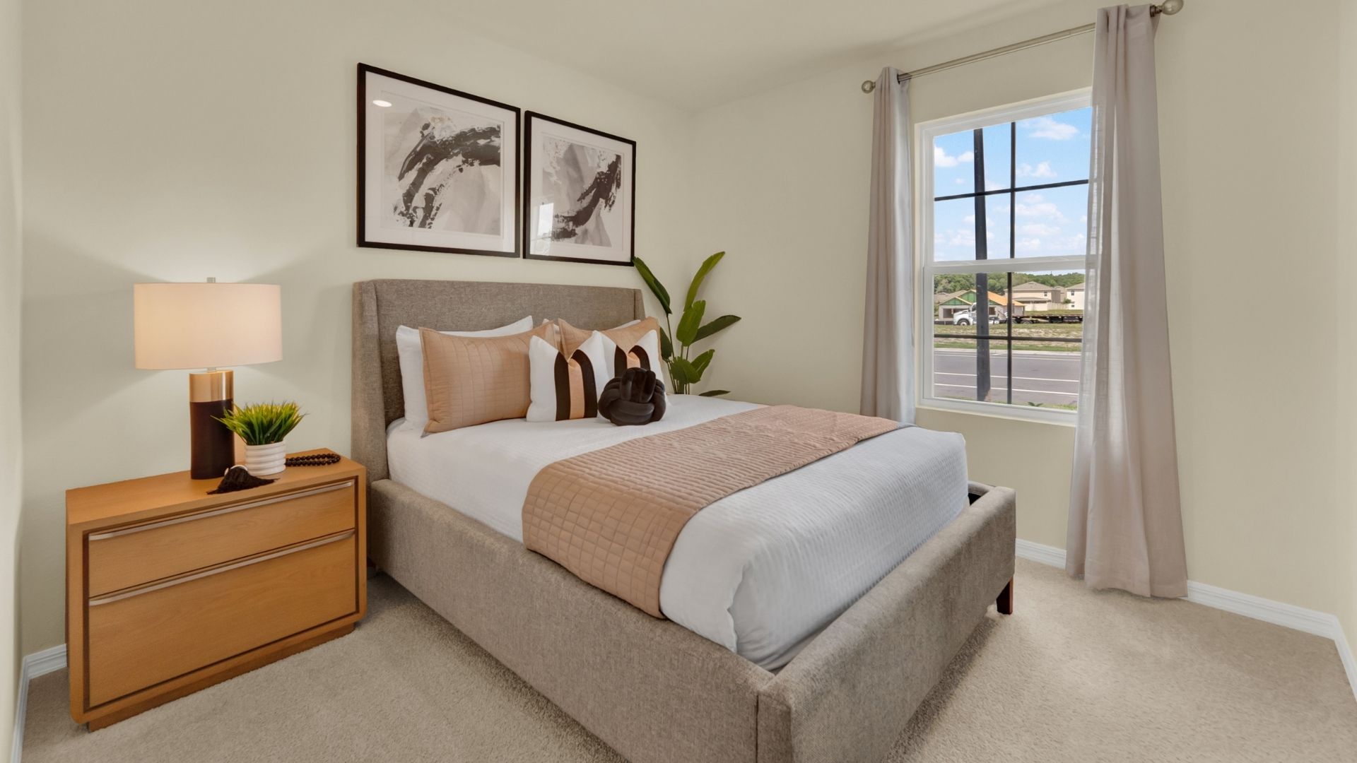 Guest bedroom with bed, nighstand and natural lighting and spacious closet.