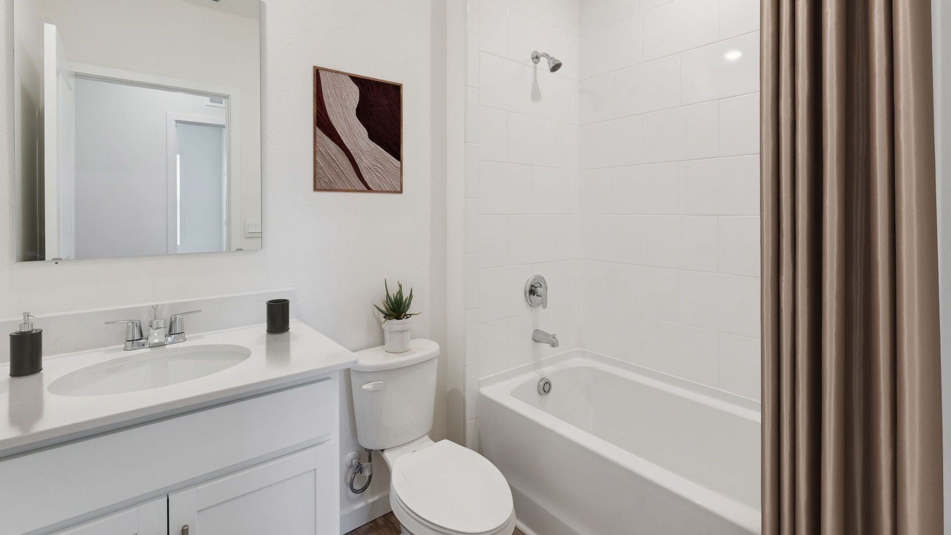 Half guest bathroom with single vanity, toilet and shower.