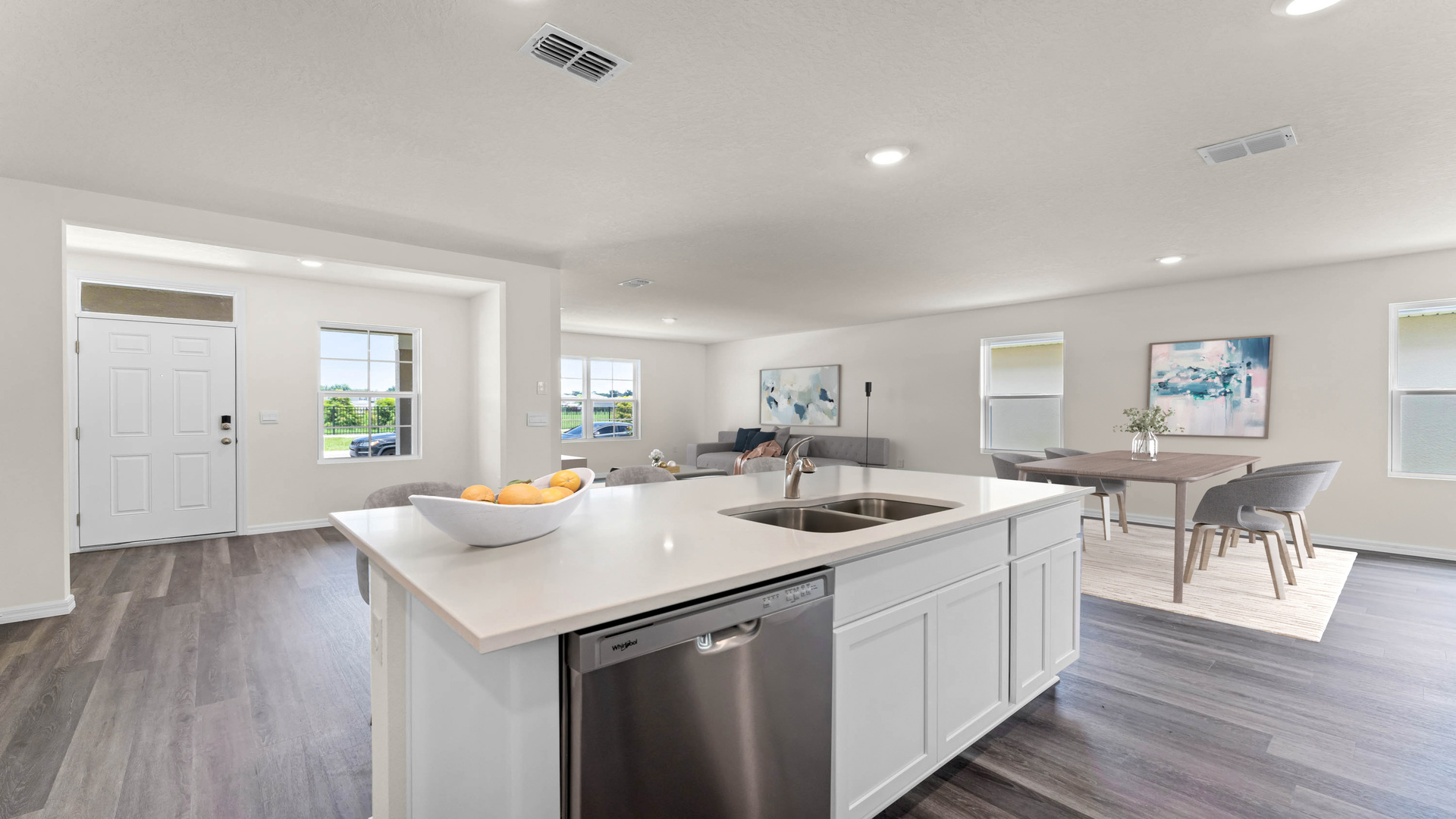 Kitchen with island seating, quartz counters, spacious pantry and stainless-steel appliances and dining room table