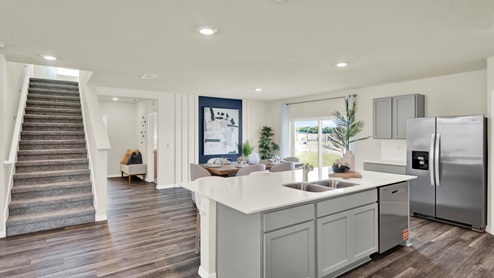 Kitchen island overseeing carpeted staircase