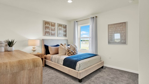 Guest bedroom with bed, nighstands and natural lighting.
