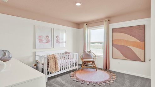 Child's nursery with crib, closet, soft seating and storage.