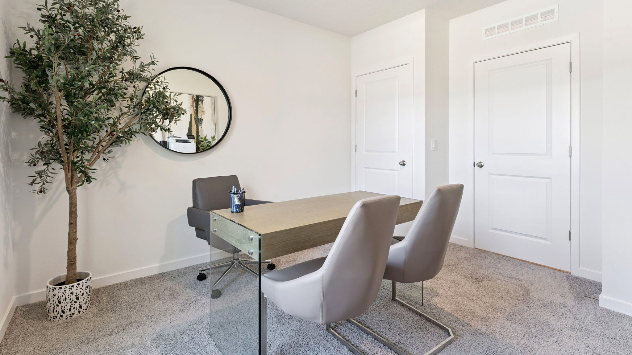 Functional home office with desk, chairs and space to work or play.