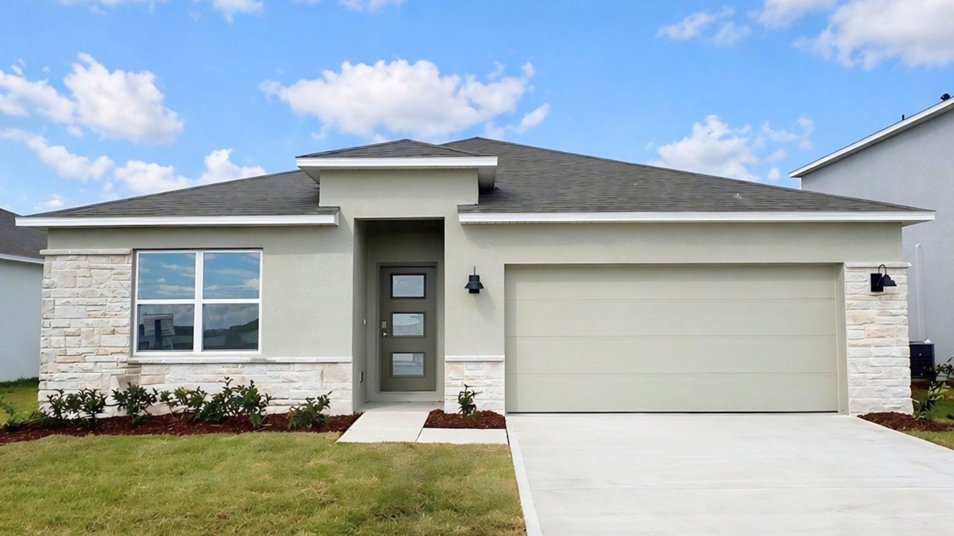 Single story new home with large windows and 3 car garage.