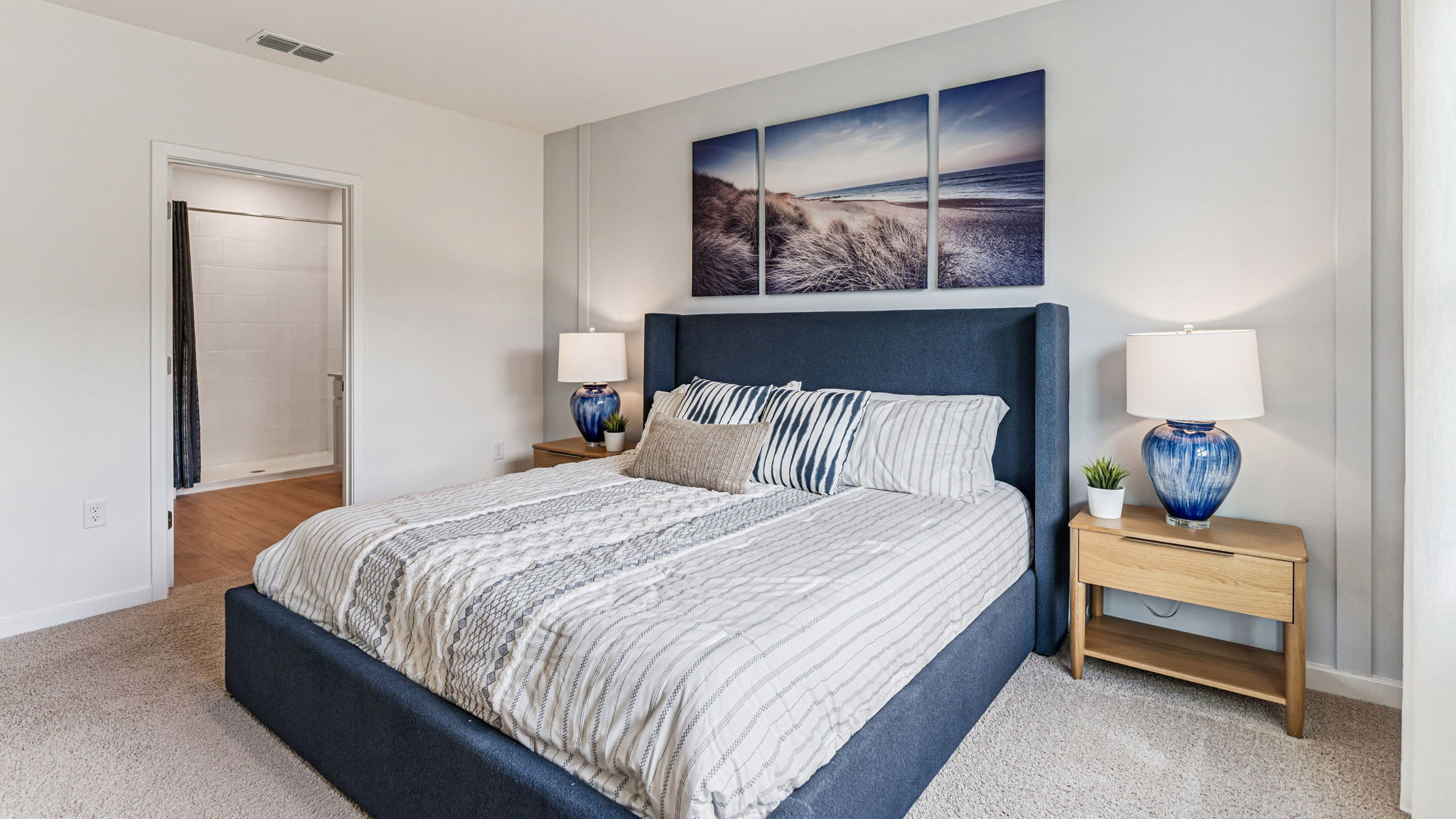 spacious primary bedroom king sized bed