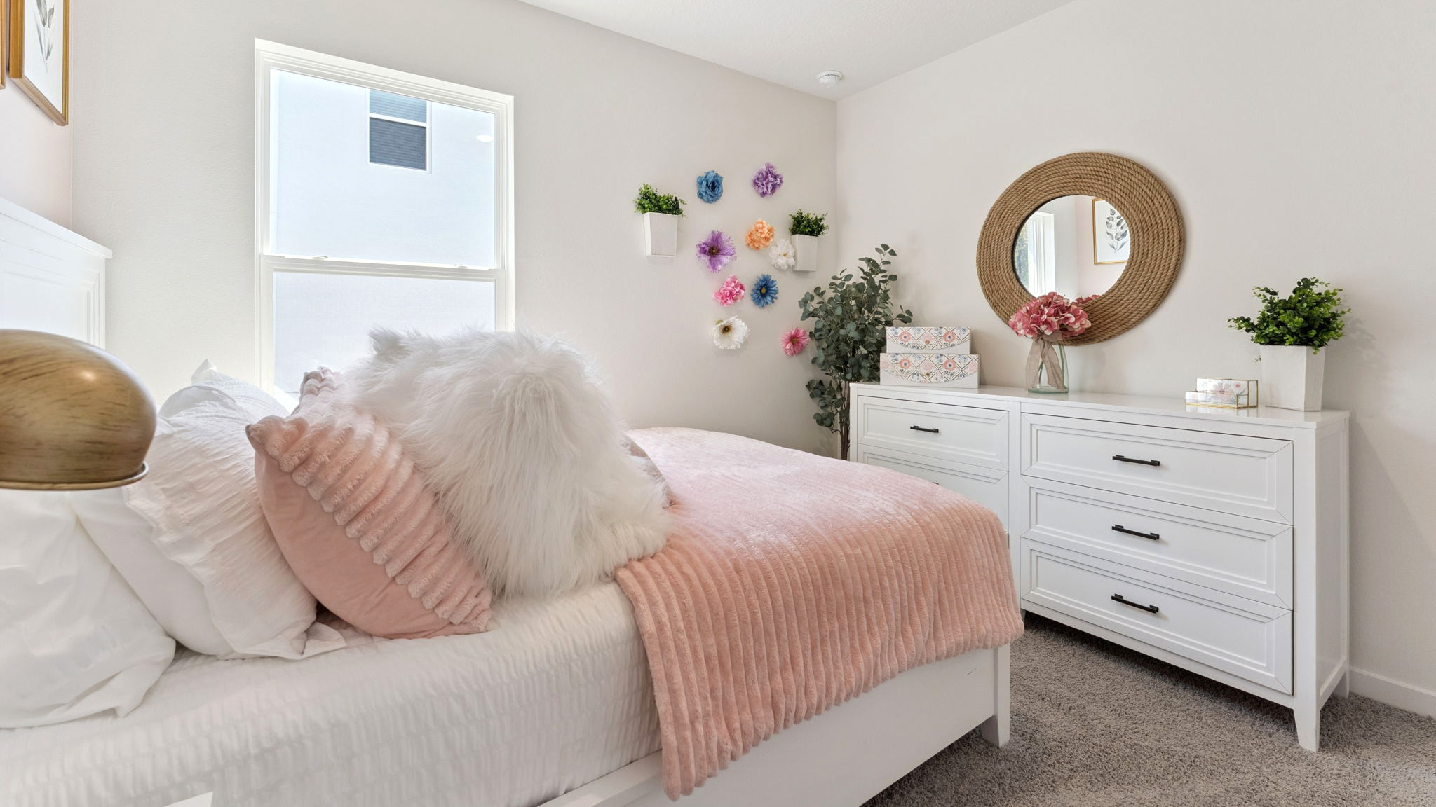 Guest bedroom with bed, nighstands and natural lighting.