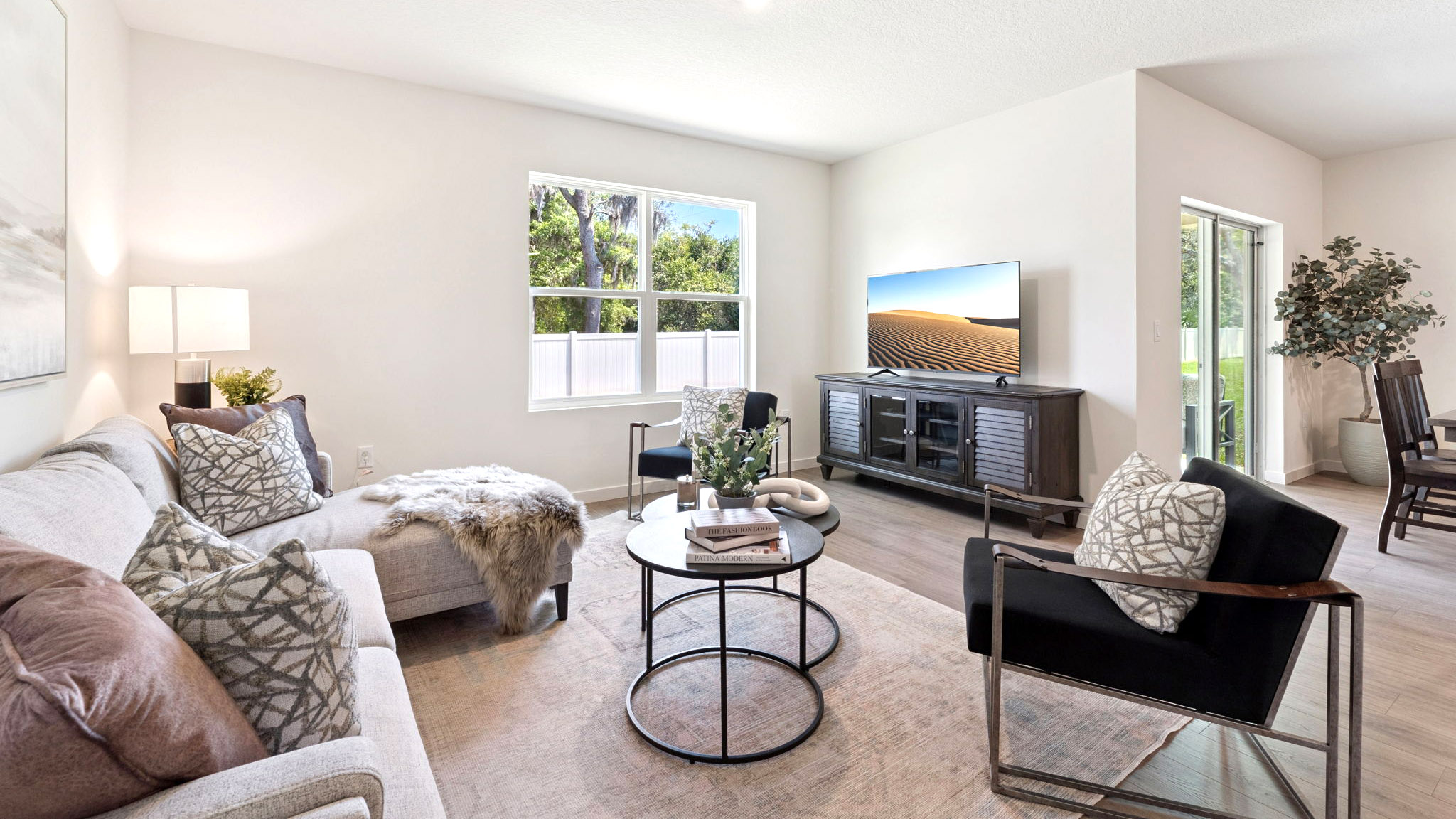Living area with couch seating, entertainment system and natural lighting