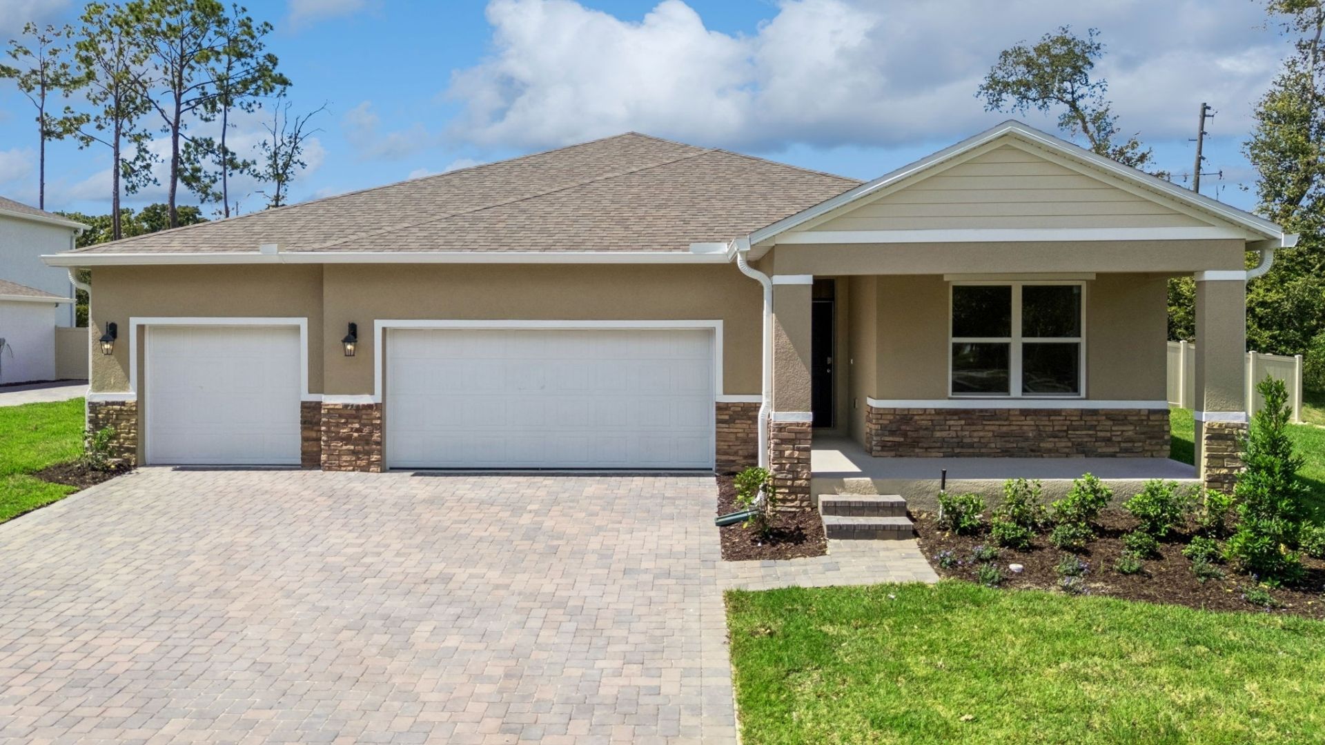 Single story new home with large windows and 2 car garage.