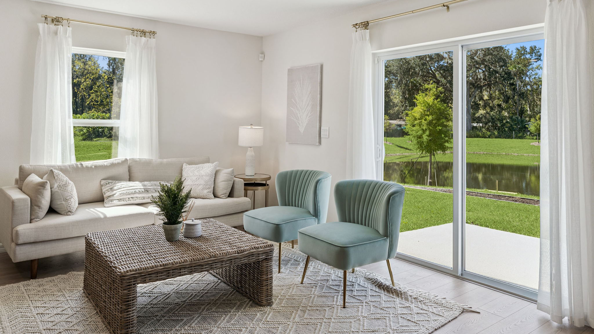 Living area with laminate flooring overseeing sliding door.