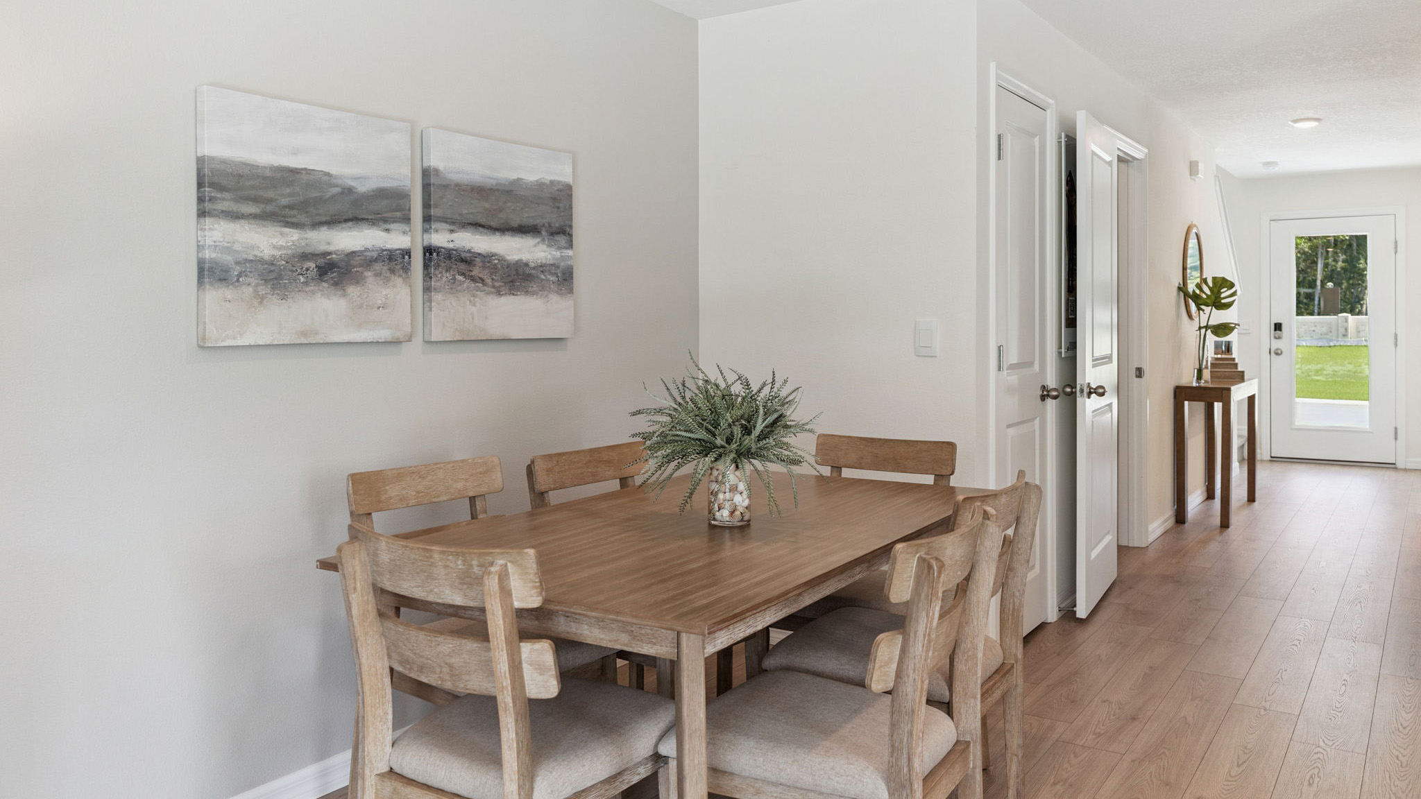 Kitchen overseeing living area and dining room table